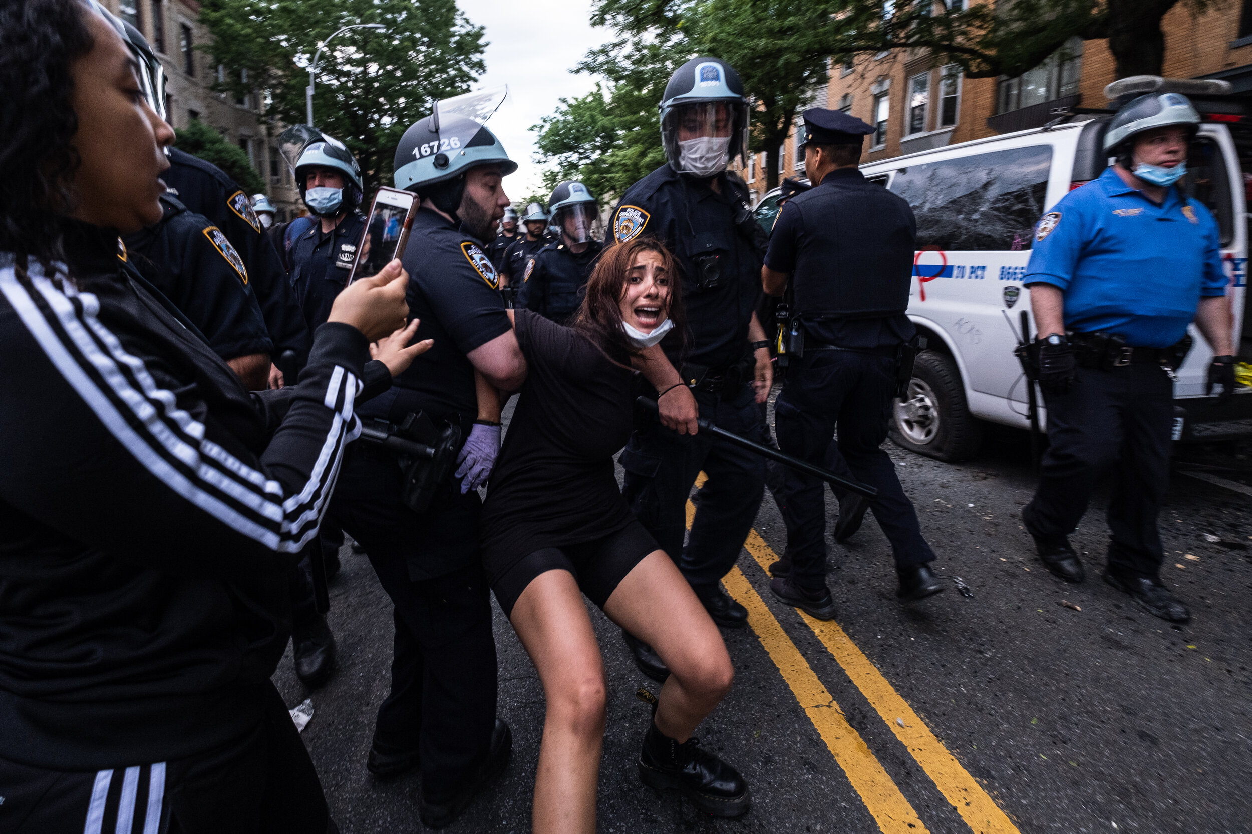  May 30, 2020: New York, NY -   A woman is detained as protesters clash with NYPD officers in Flatbush, Brooklyn after George Floyd was killed while being detained by Minneapolis police on May 25.  