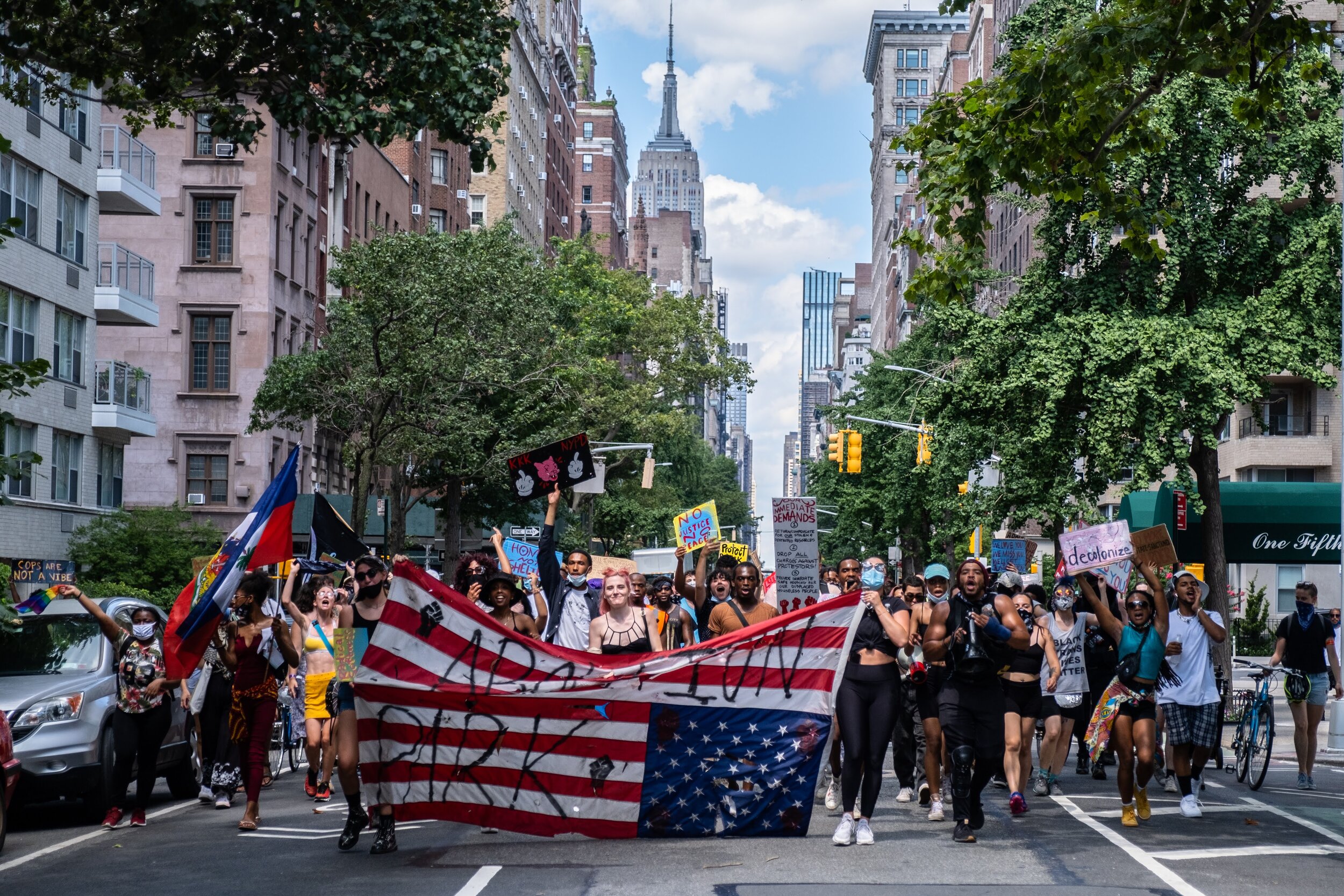  June 6, 2020: New York, NY -   People walk down 5th avenue towards Washington Square Park during a protest after George Floyd was killed while being detained by Minneapolis police on May 25.  