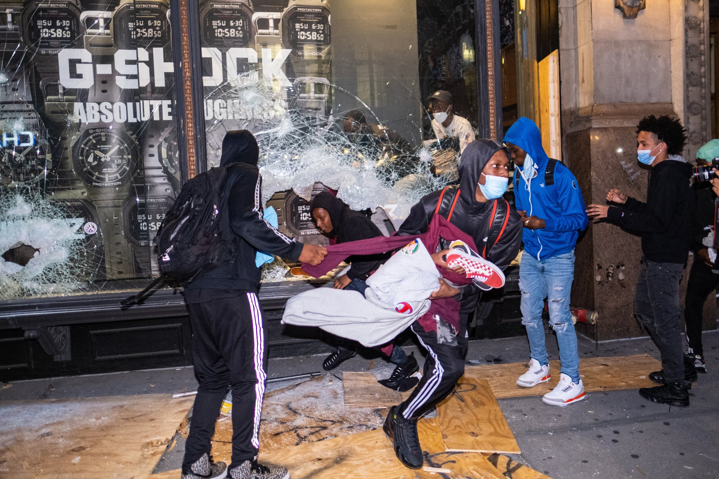  June 1, 2020: New York, NY -   People take goods from a clothing store during widespread looting in Manhattan after George Floyd was killed while being detained by Minneapolis police on May 25.  