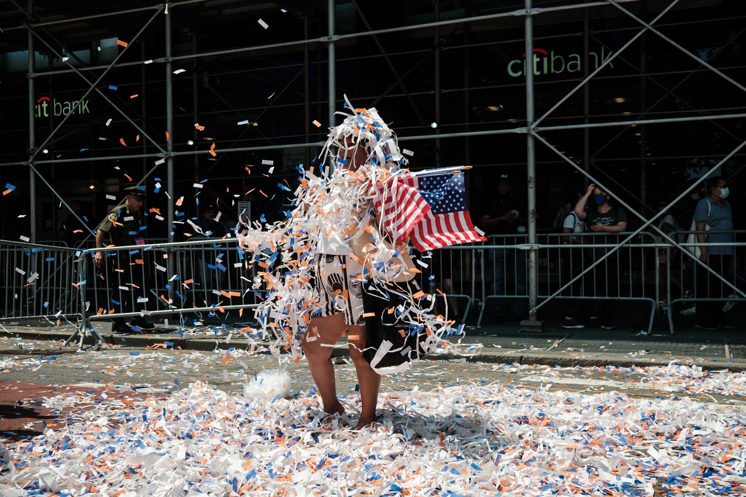  A woman is covered in ticker tape after a parade for essential workers during the covid pandemic in NYC 