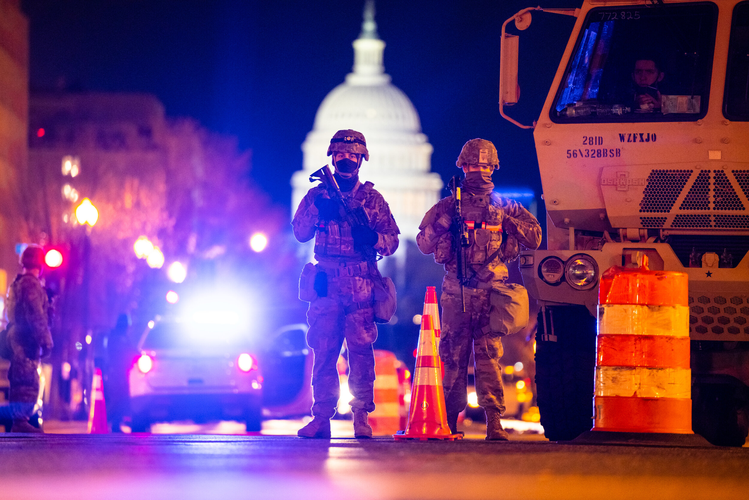  Members of the National Guard and DC Police form a perimeter around the Capitol Building in downtown DC ahead of the 2021 Inauguration a week after right wing groups invaded the building.  