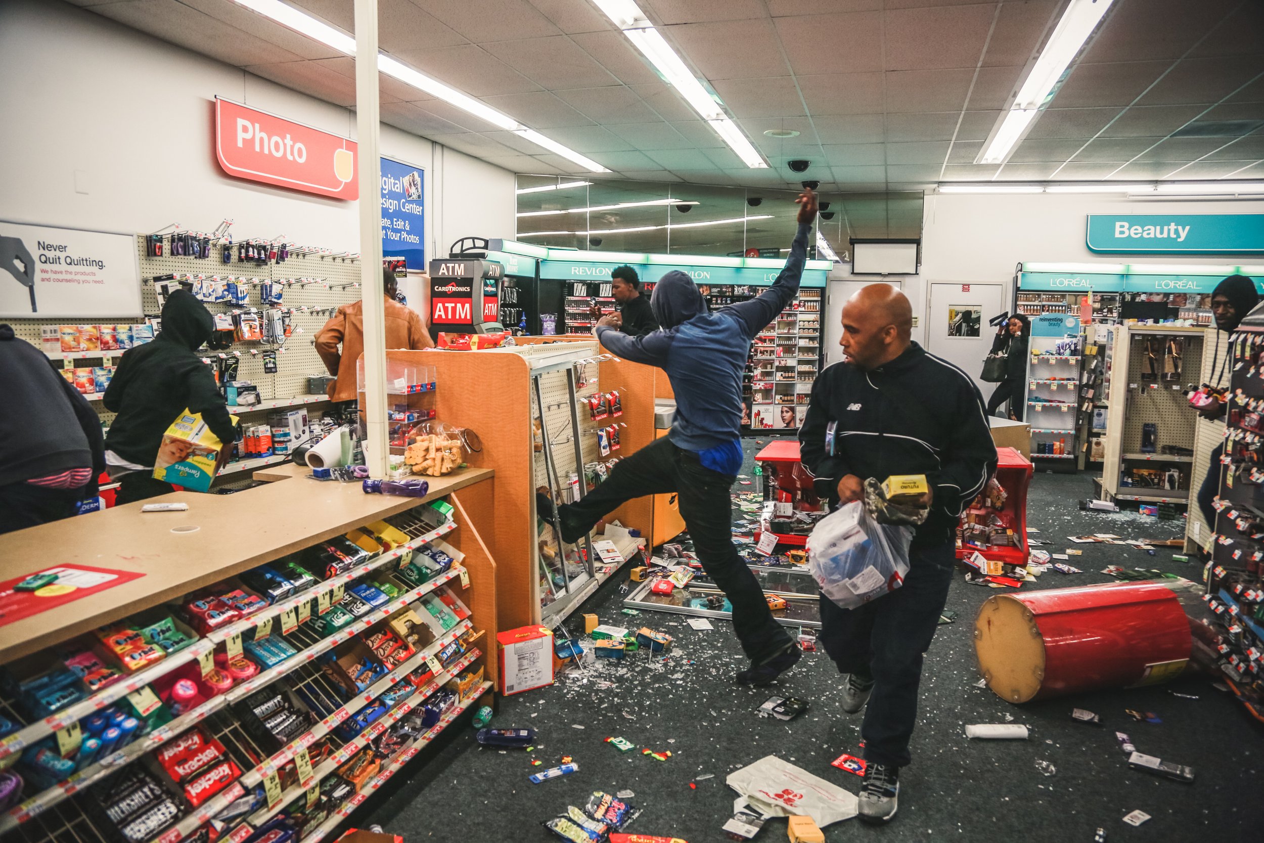  People loot a Walgreen’s during a riot after the funeral for Freddie Gray, who was killed in police custody in Baltimore 