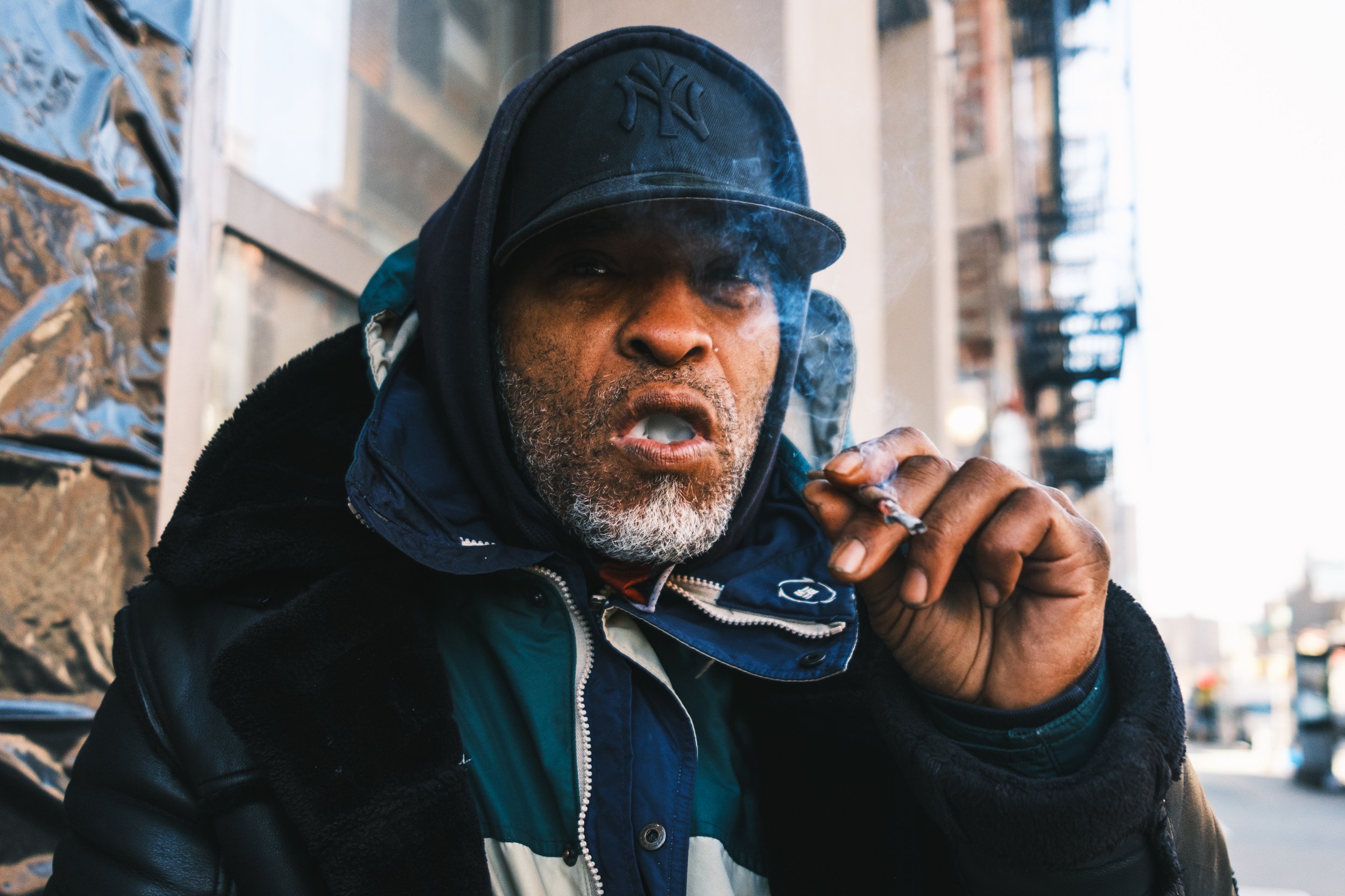  A man smokes a fentanyl laced K2 joint on Bowery in Manhattan 