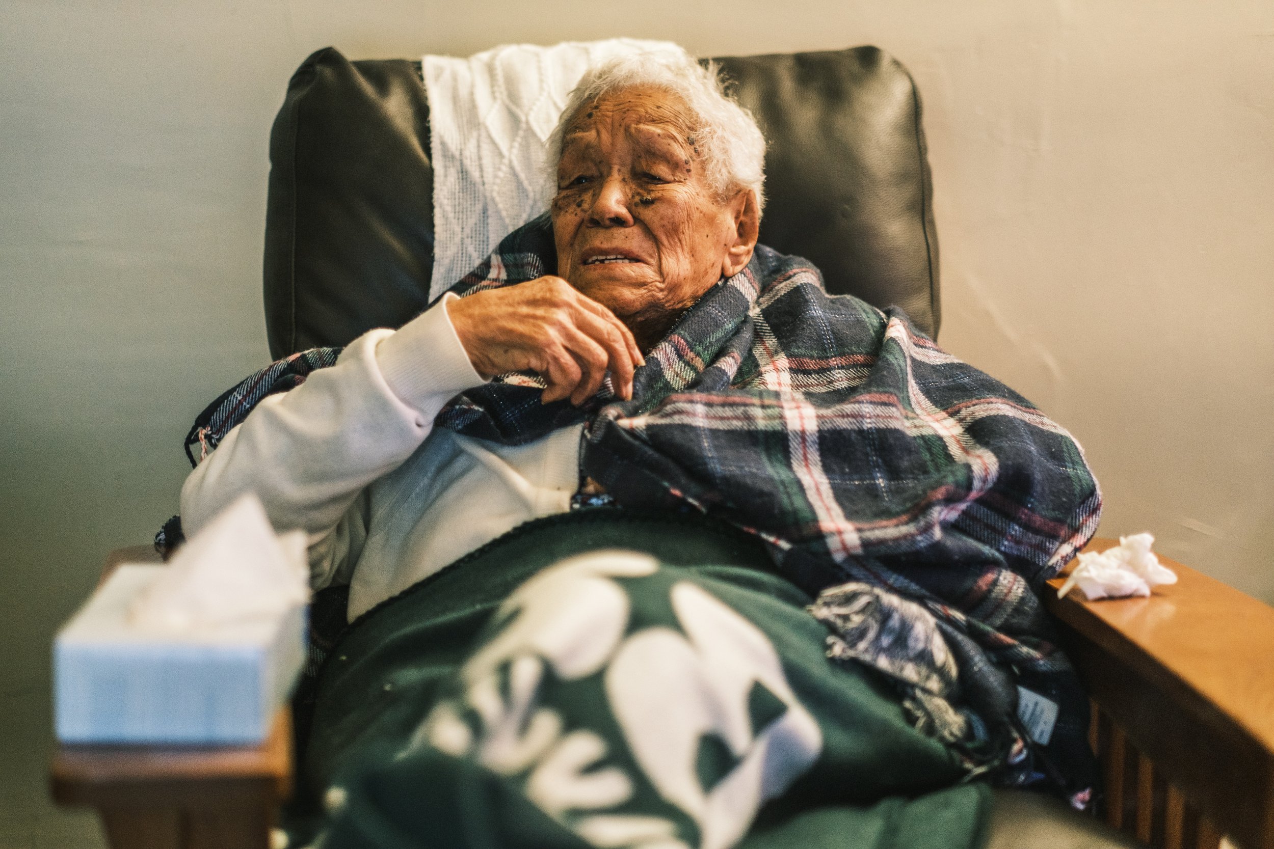  December 24, 2021 - Bronx, NY:  NYCHA resident Rosa Velasquez, 98, sits covered in blankets in her apartment, which has no heat. Velsaquez’s apartment building at the Bronx River Houses in the Bronx has not had heat in two weeks and despite multiple
