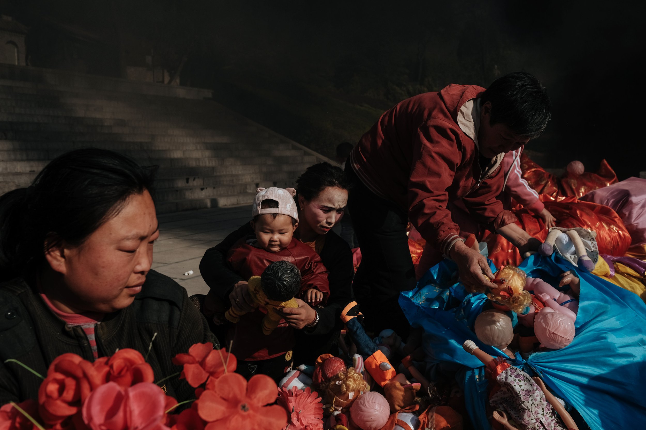  People sort through donated dolls at a temple in Handan, China. 