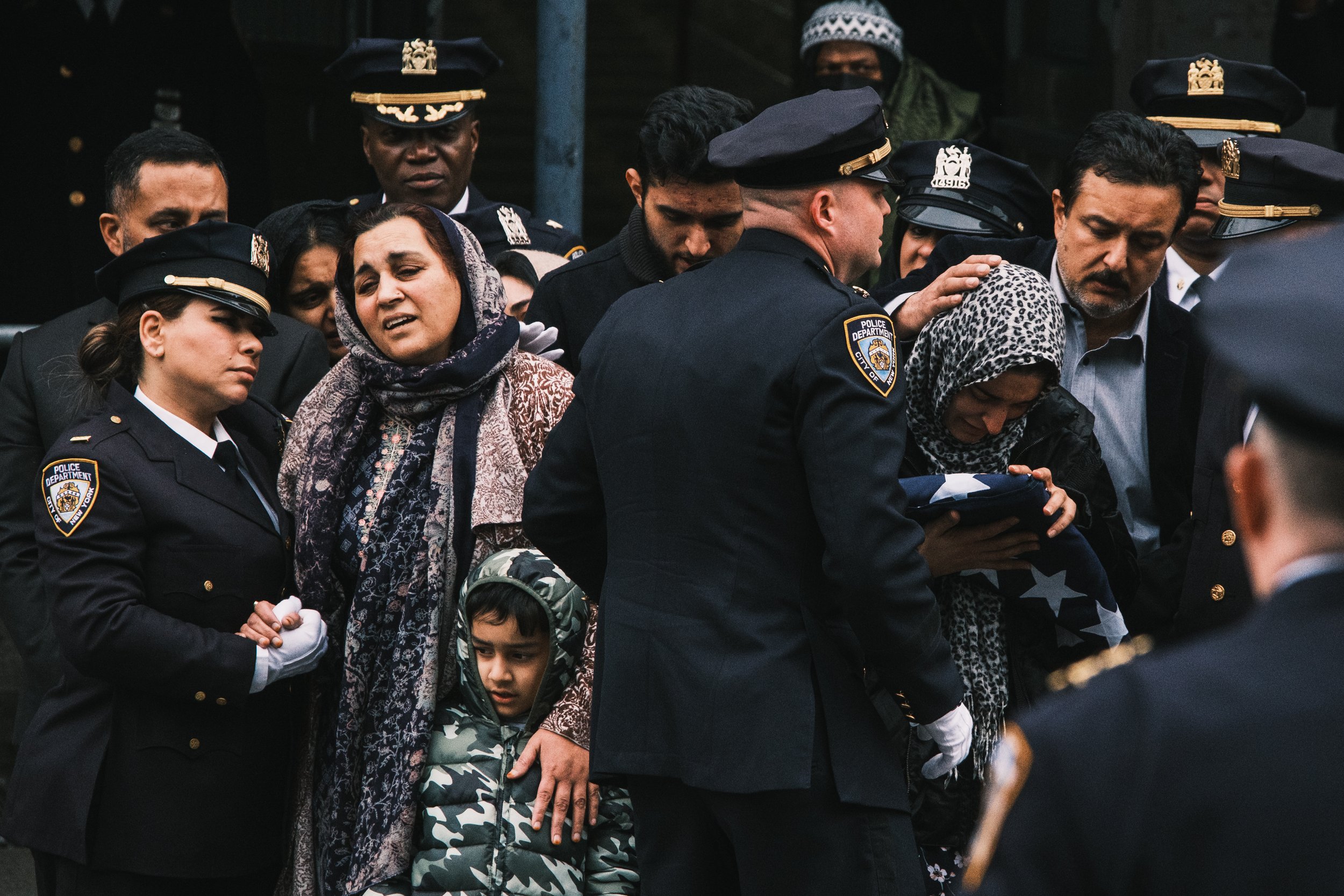  NYPD officer Adeed Fayaz’s family is given a ceremonial flag at his funeral in Brooklyn.  
