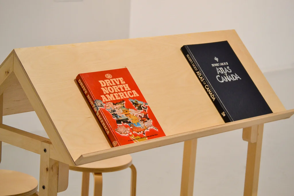 what is and what was art installation by jackie partridge of found atlases on table
