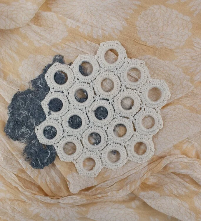 lace artwork made with white doily and denim pulp