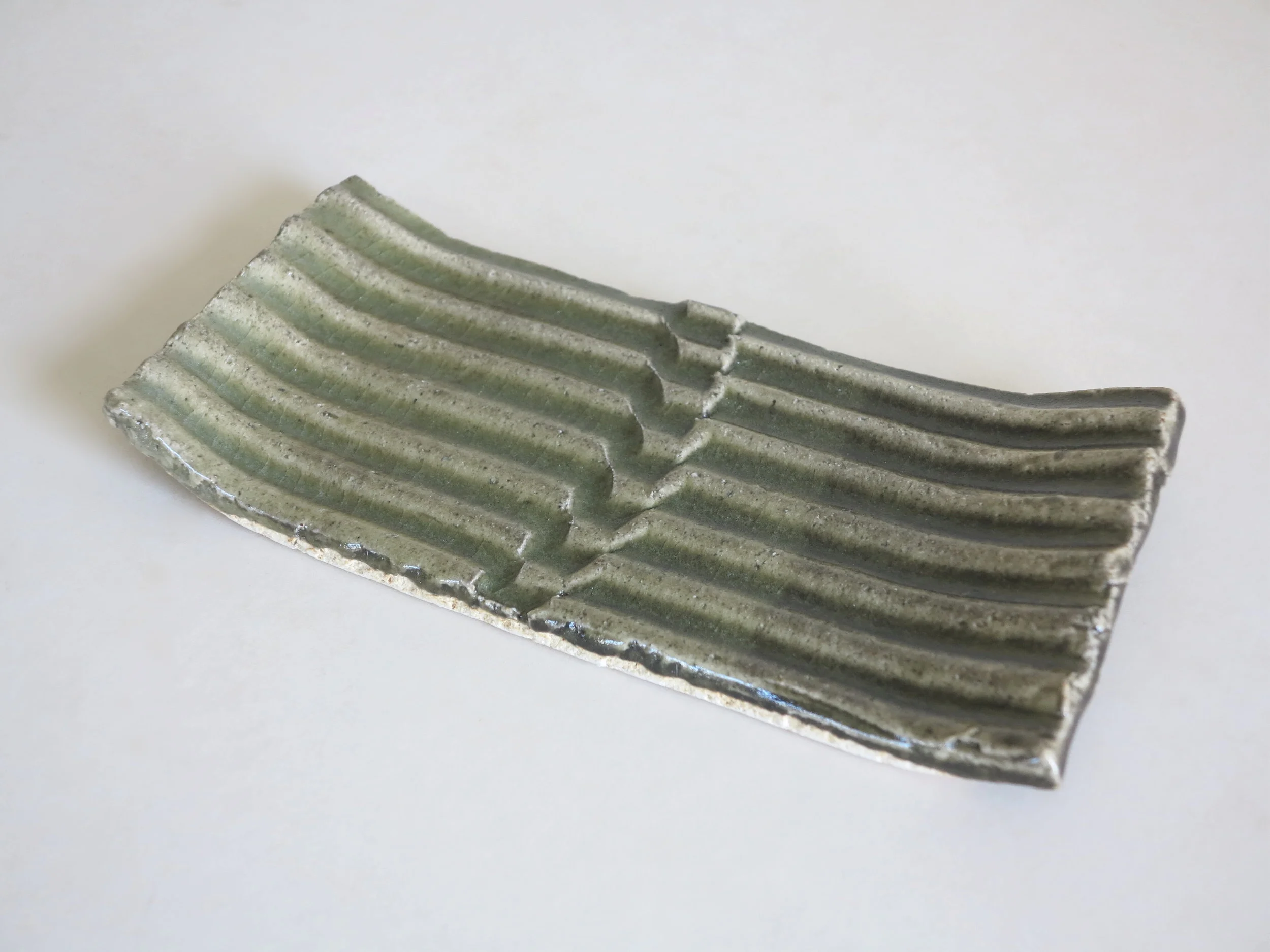 Late 1960s grooved stoneware tray with celadon glaze by Teruo Hara (1929-1985). 10.25" l.  