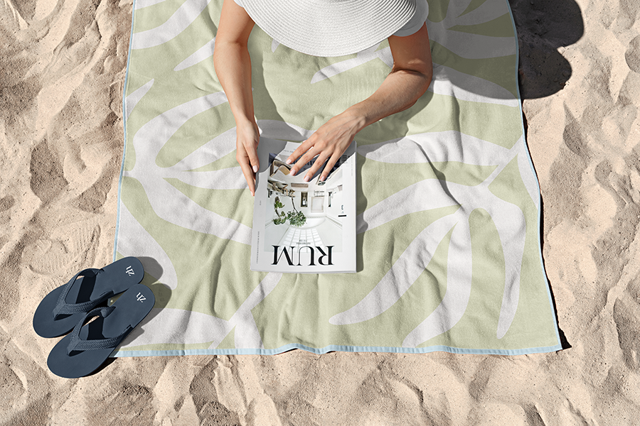 The iconic Zen House pattern on a beach towel with flip flops branded with the logo icon.
