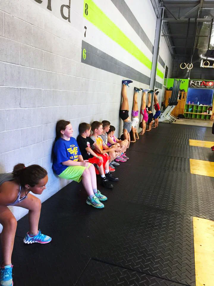 CrossFit-Mantra_CrossFit-Kids_Wall-Sits-and-hand-stand-push-ups.jpg