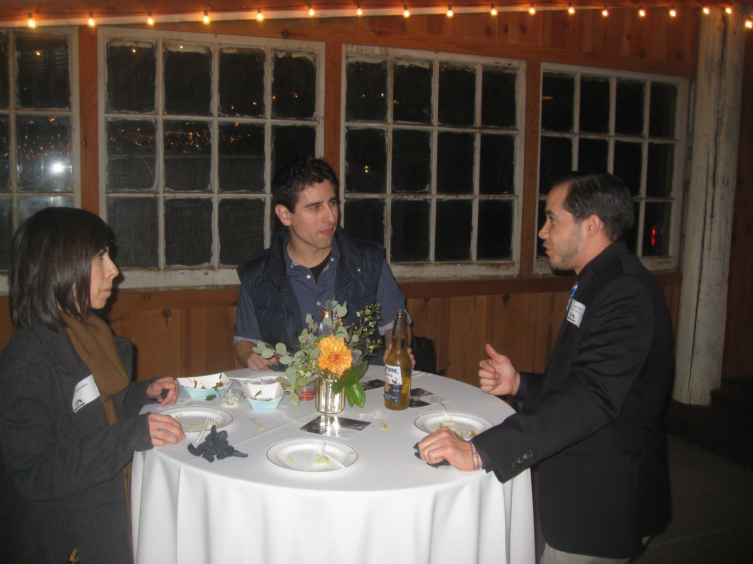 YPN Committee member Joel Rosales makes a new connection with Valerie & Luis Mota during the YPN Mixer on January 22nd.JPG
