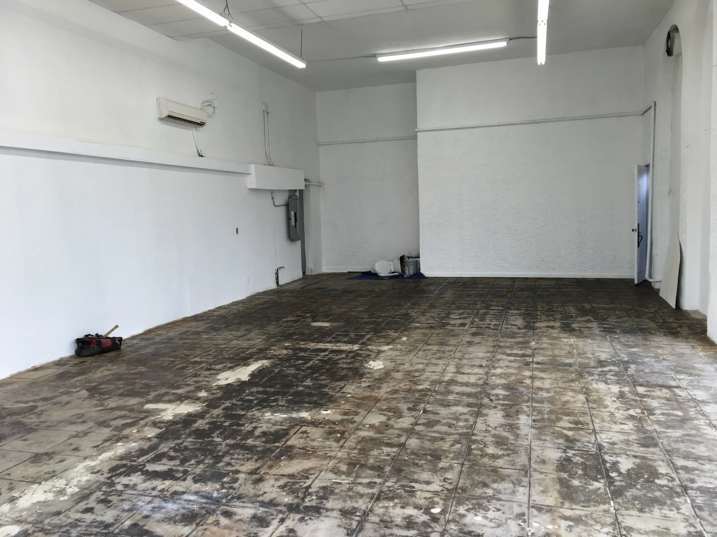 Concrete floor is scraped, sanded and sealed. 