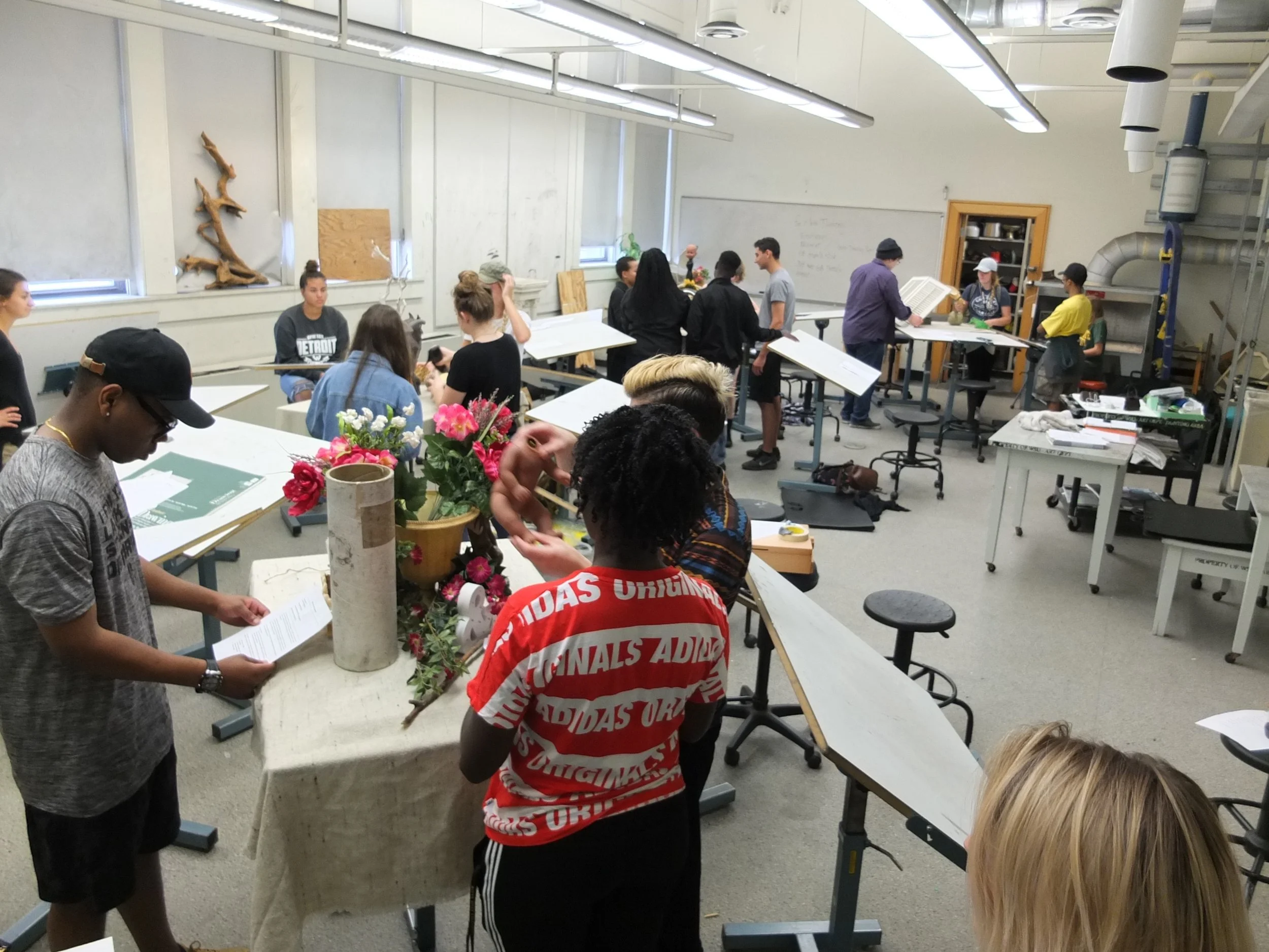 Students work in small groups to build still-life set ups using concepts of composition.