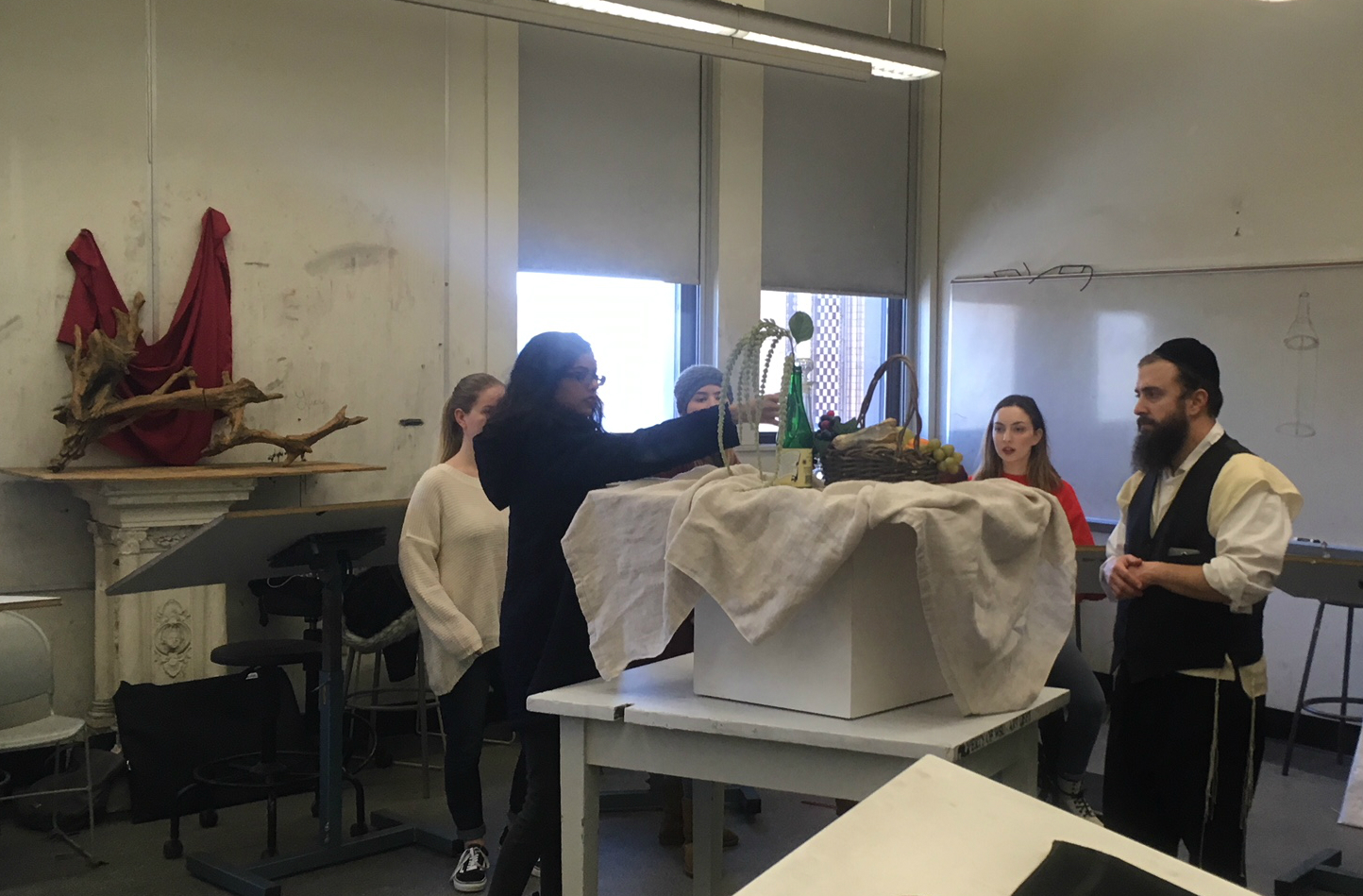 Students work in small groups to build still-life set ups using concepts of composition.