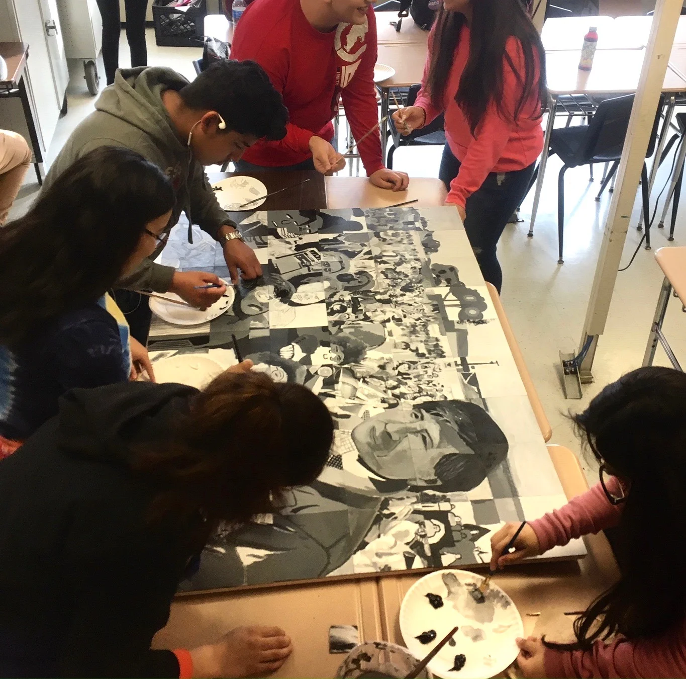 High school students put the finishing touches on a class mural for Cesar Chavez Day of Service.