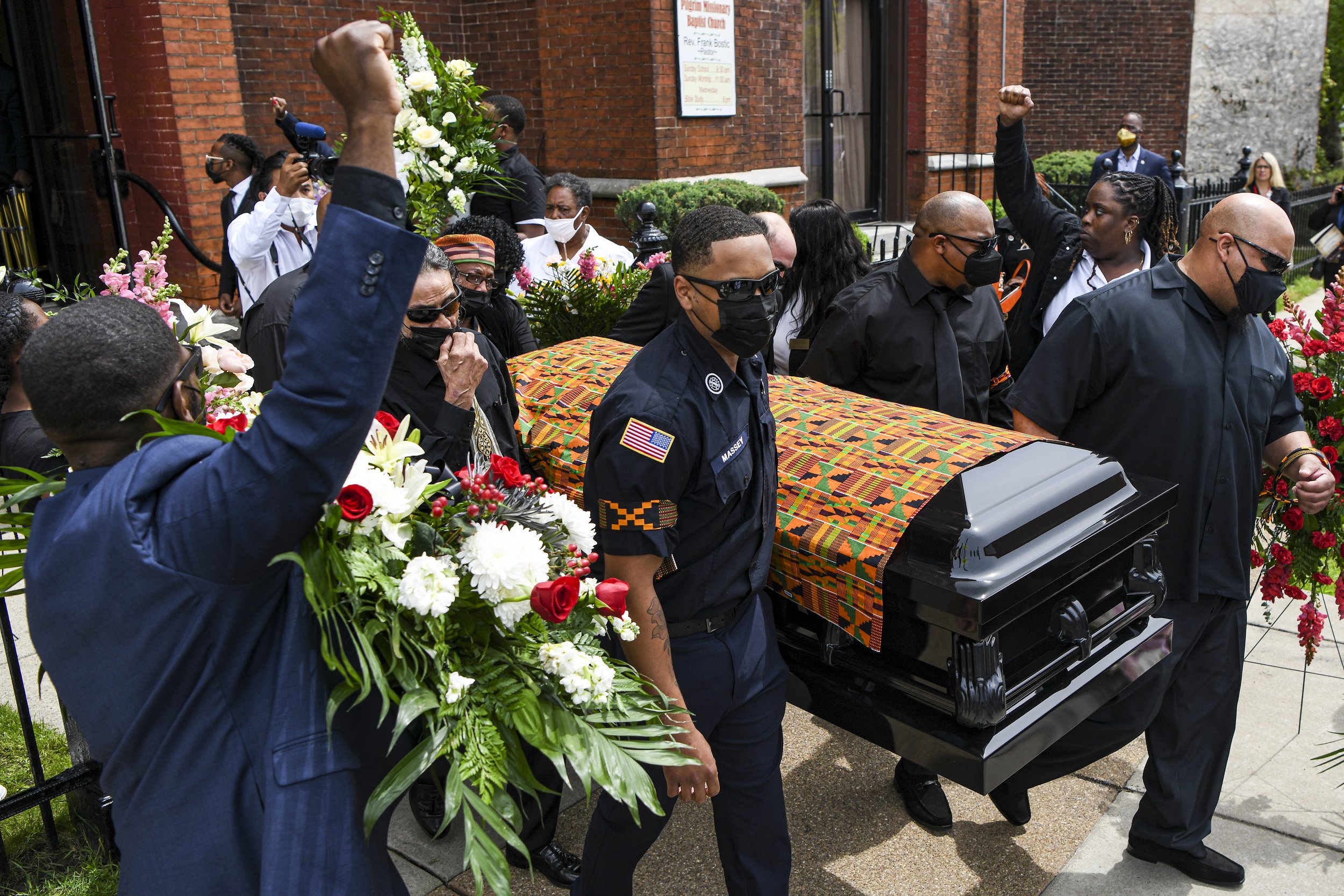  Katherine Massey’s casket is draped with her favorite African Kente cloth as pallbearers carry it out of the Pilgrim Baptist Church. 