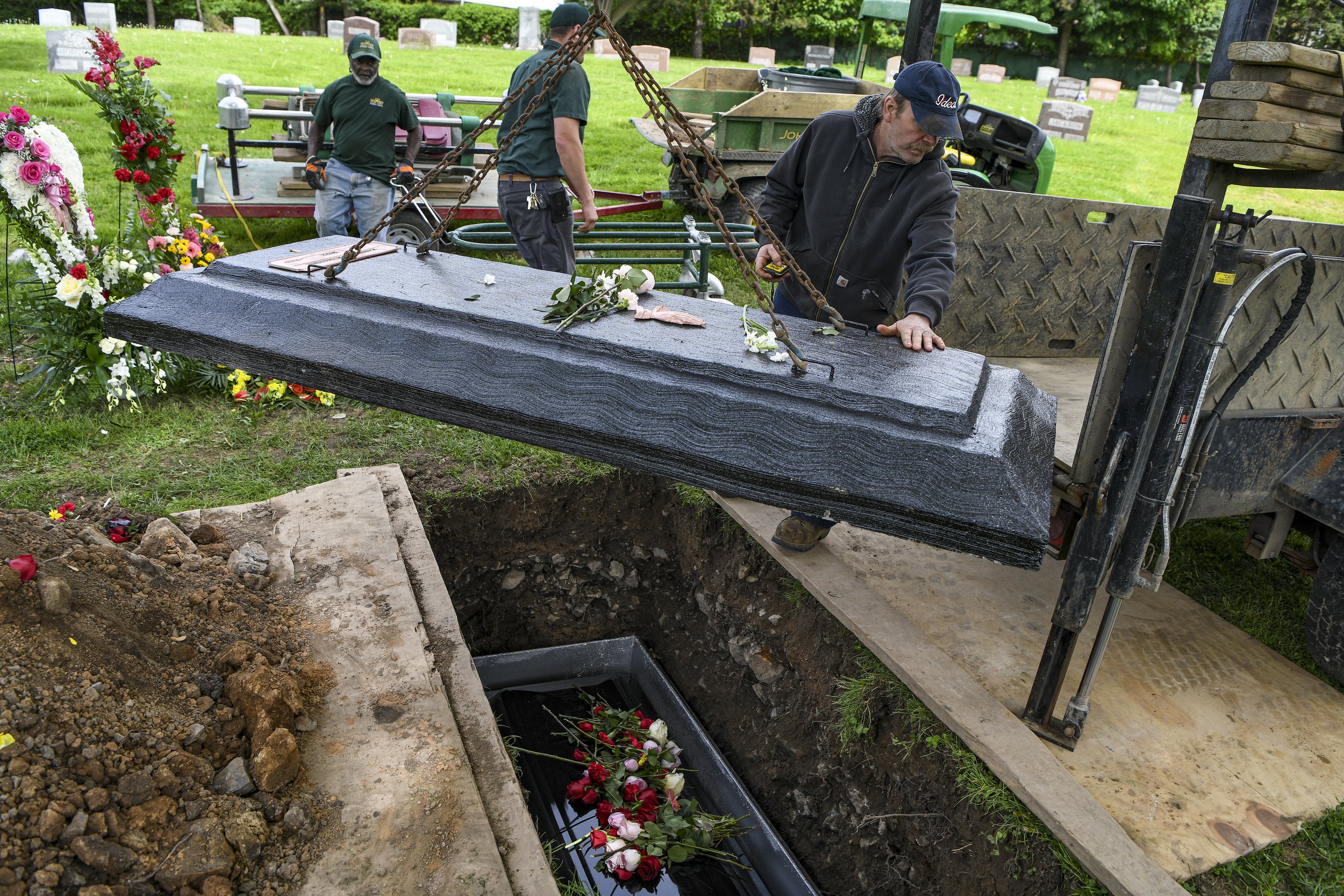  Gravediggers at Forest Lawn Cemetery finalize the burial of Katherine Massey.  