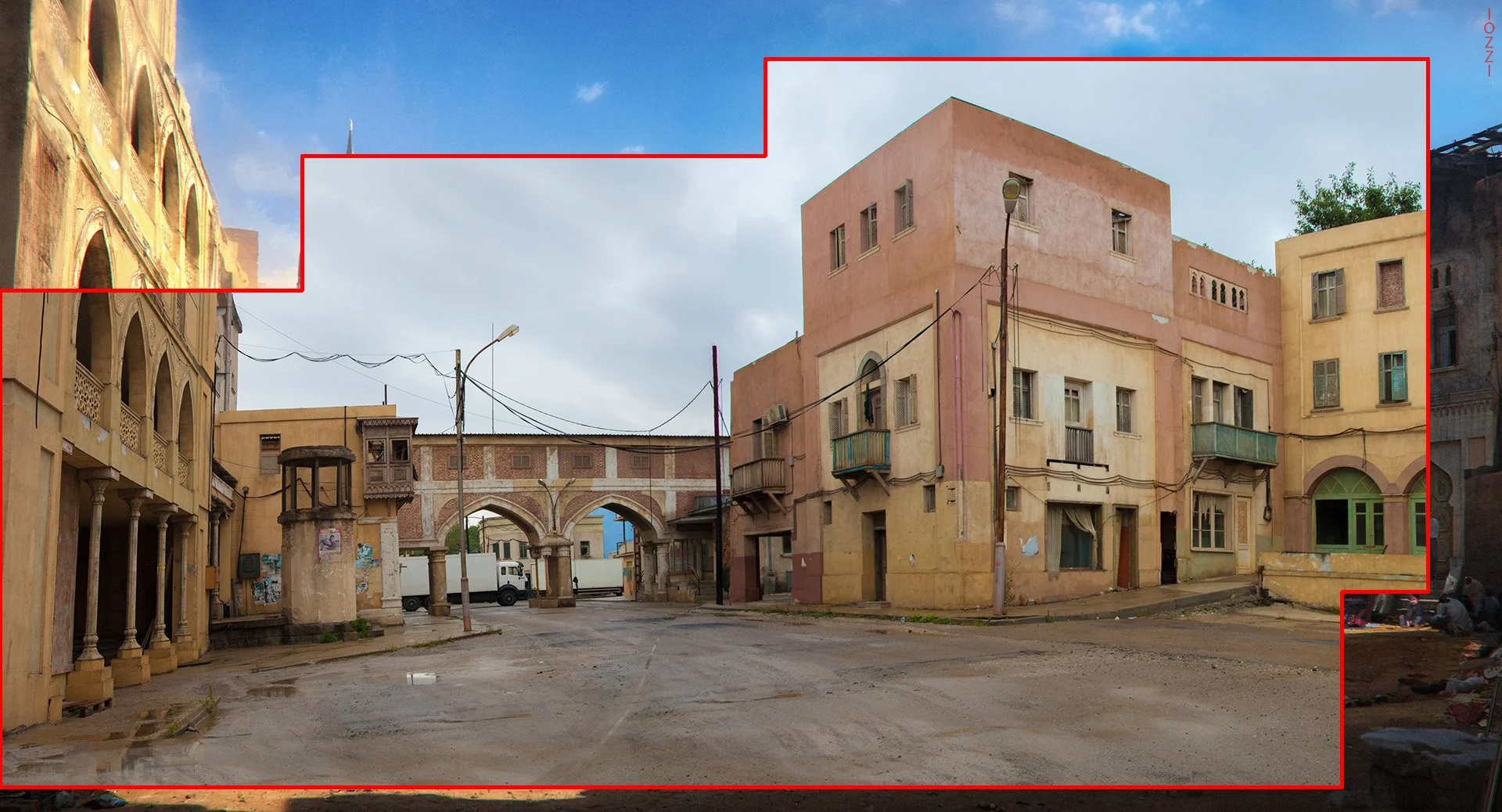 A street scene with multi-story buildings, some with balconies, an arched bridge structure, utility poles and wires, trucks parked in the background, and a group of people sitting on the ground on the right side. The buildings are in pastel colors, a