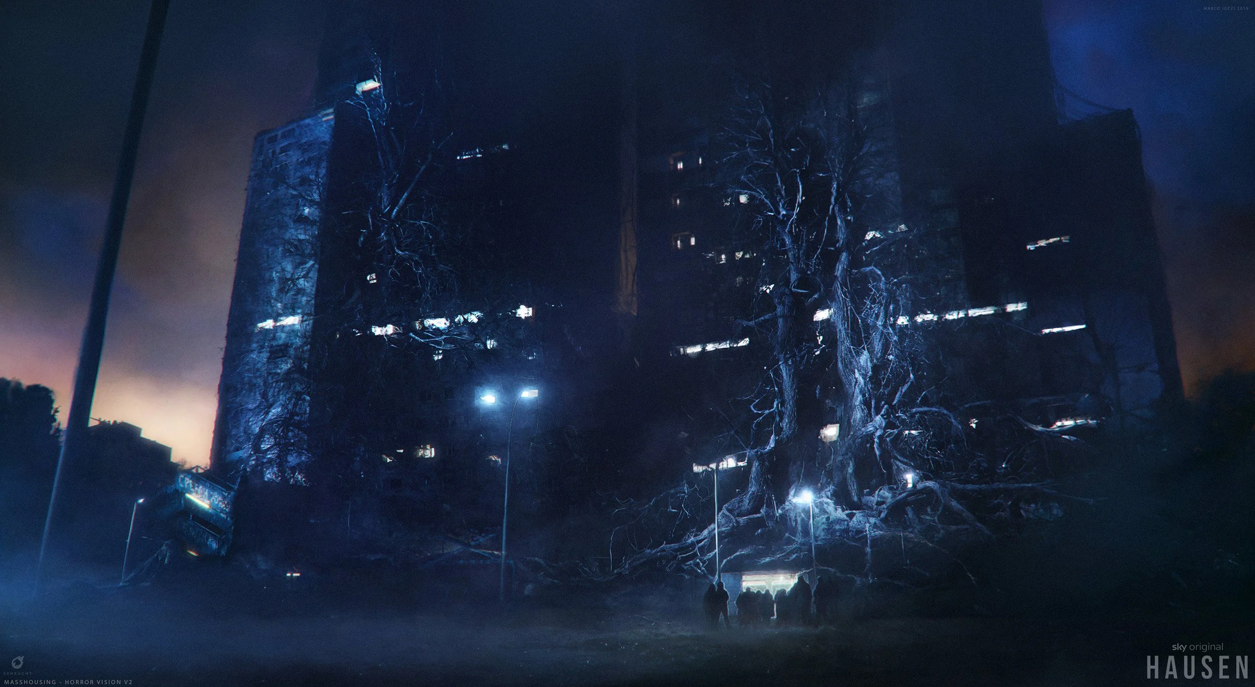 Nighttime scene of a dark building with many windows and a large, leafless, gnarled tree in front, illuminated by multiple blue streetlights. Four people are walking near the tree, and the sky is cloudy with a faint glow in the background.