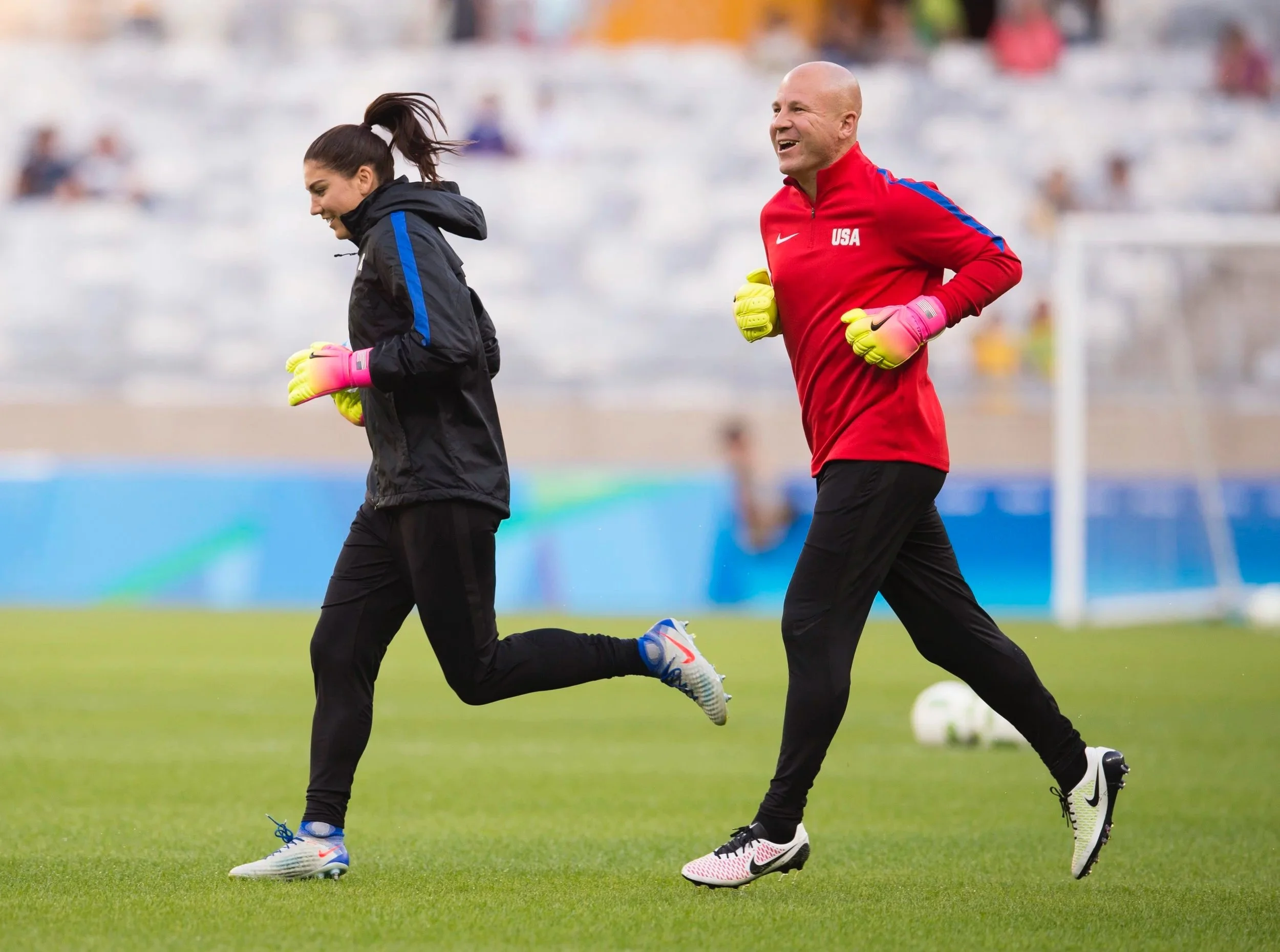 Hope Solo and Graeme Abel enter the field for the 2016 Olympic Games in Rio, Brazil.