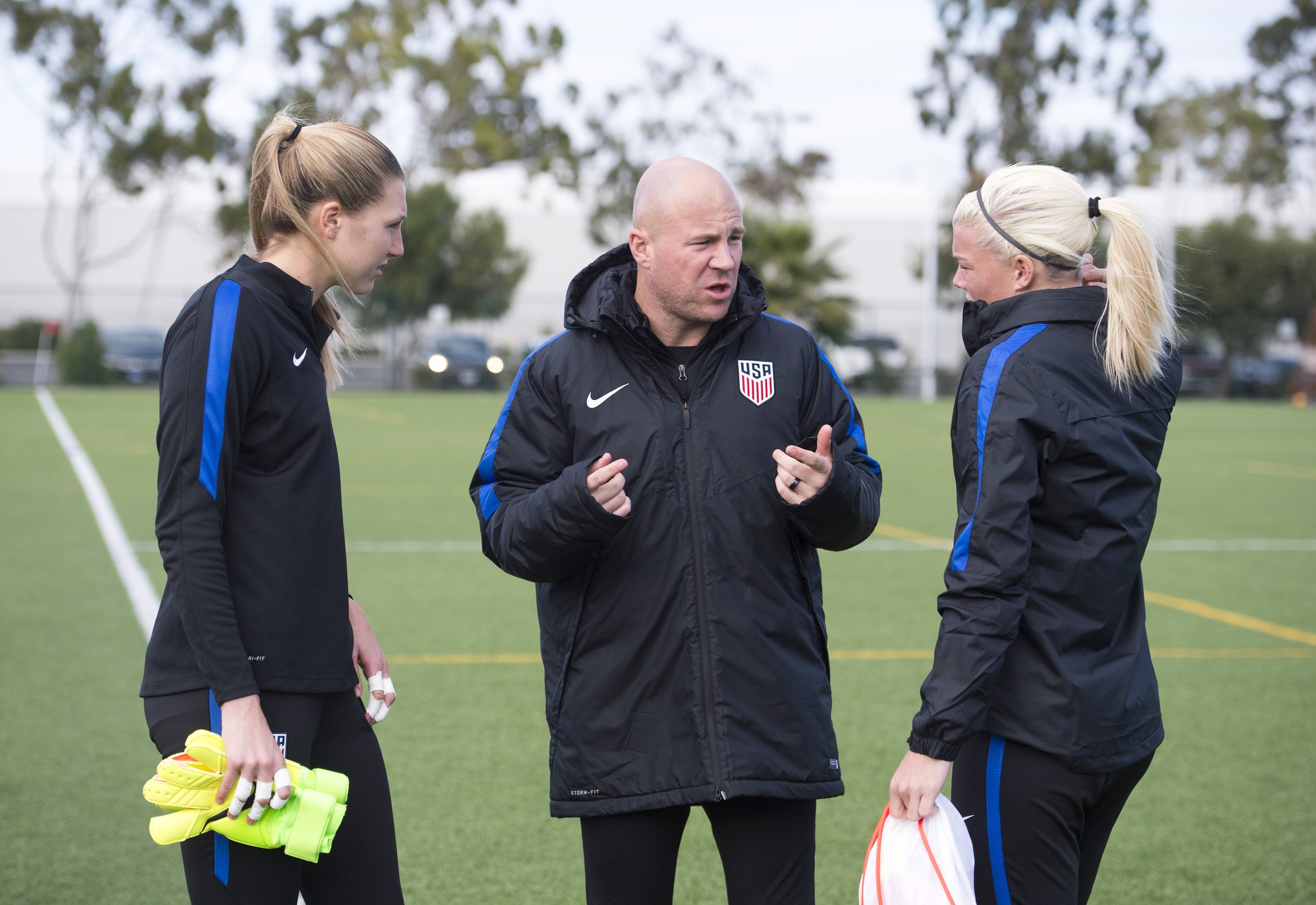 Jane Campbell and Casey Murphy chat with goalkeeper coach, Graeme Abel, during US Women's National Team camp in Carson, California.