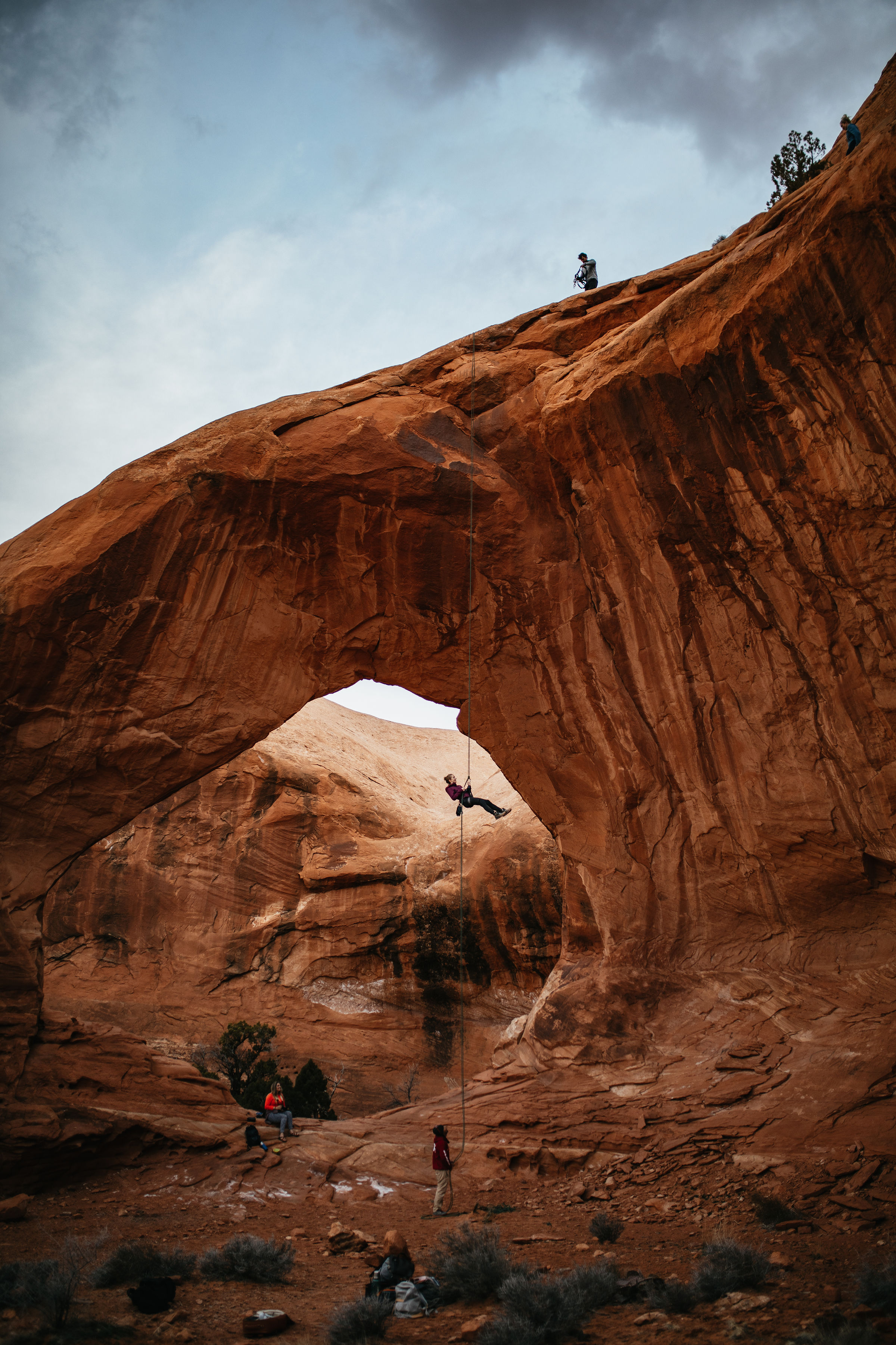 Repelling down a large arch in Moab, Utah | Arches National Park Photography