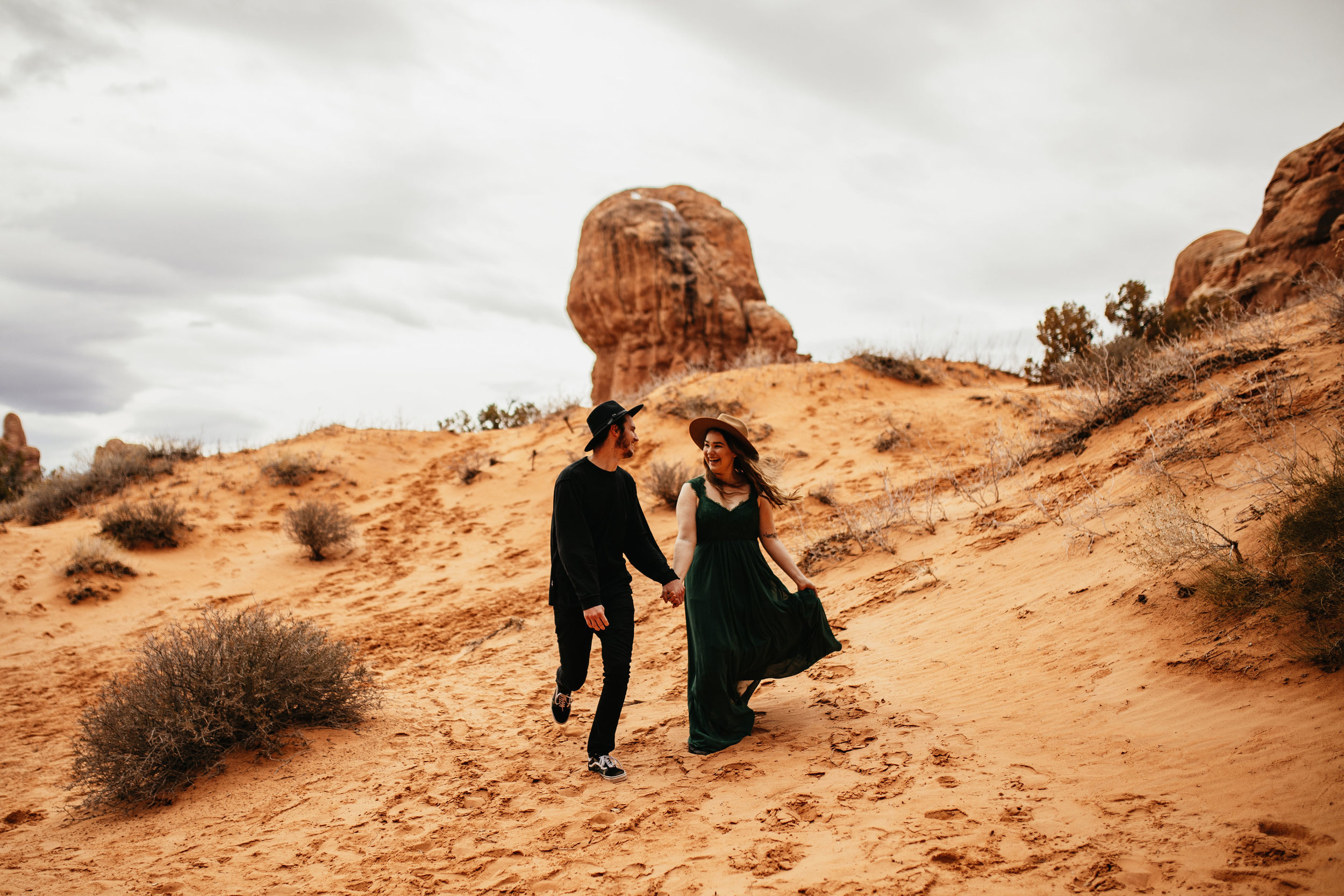 Running through the desert in Moah | Utah Couple Photographer