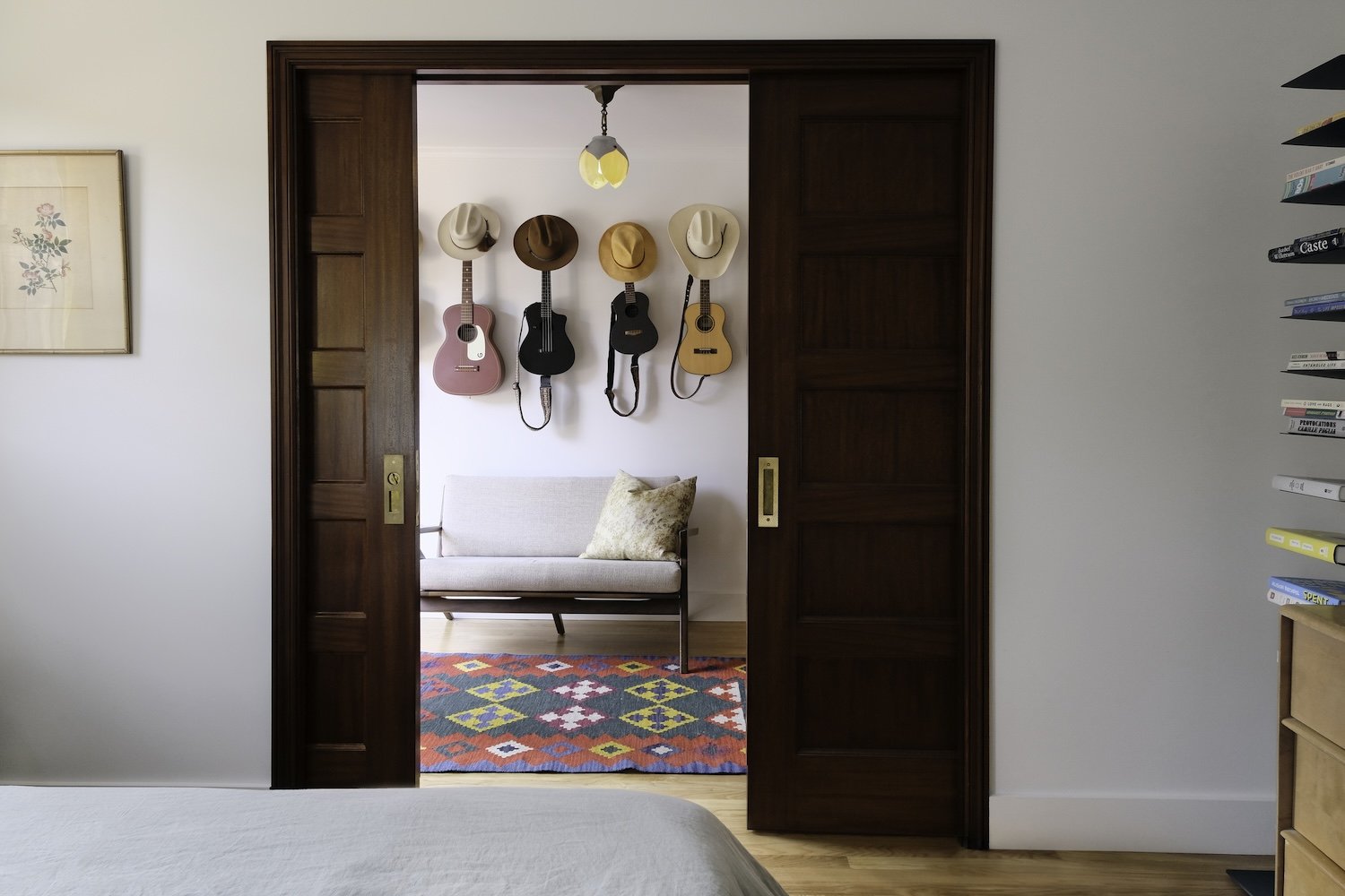 sitting room with stain grade wood double pocket doors and vintage light fixture.jpg