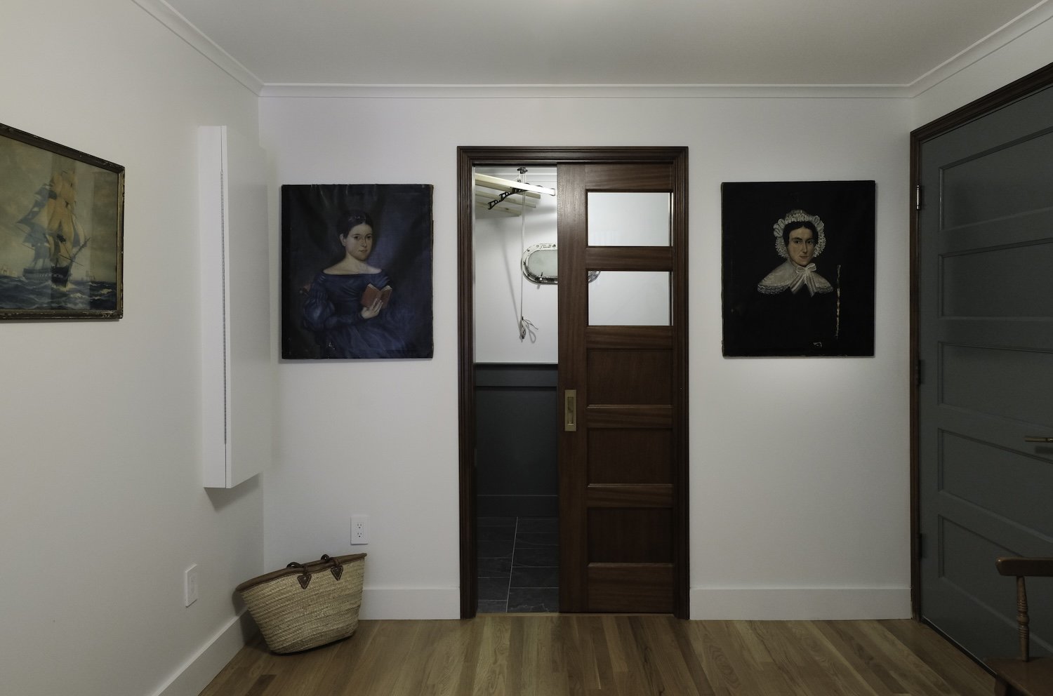 entry area with stain grade wood trim and medium wood floors and green accents.jpg