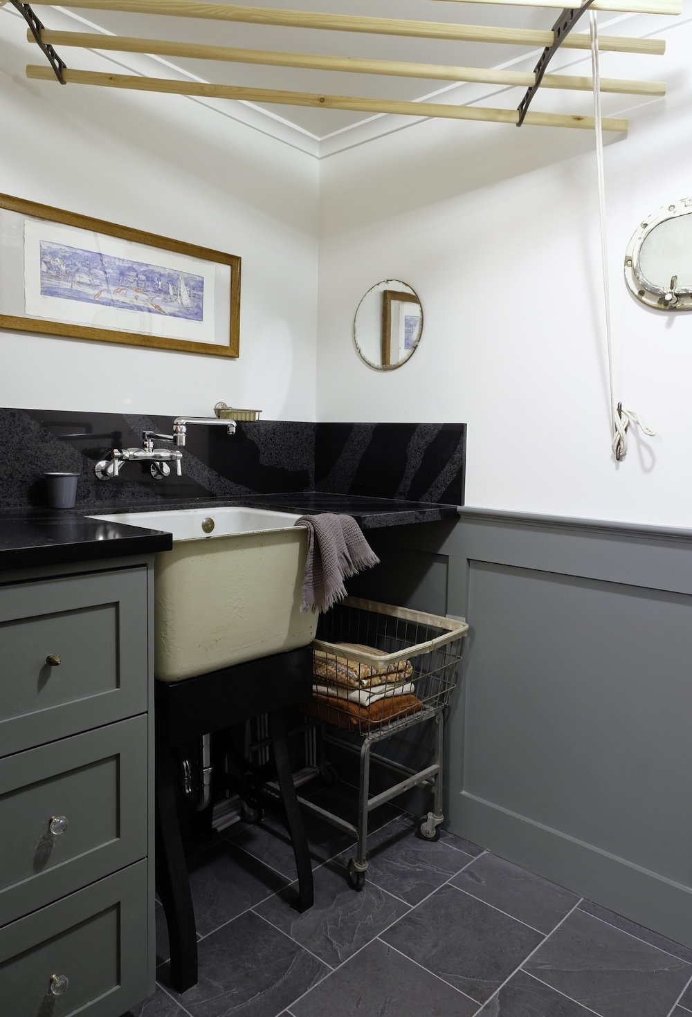 Laundry room with vintage sink and adjustable hanging rack and custom wainscoting.jpg