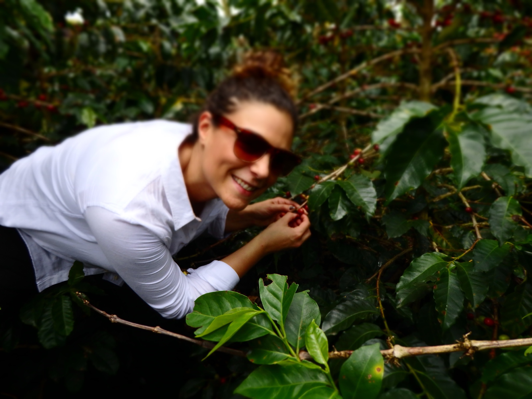 Owner, Alyza Bohbot, visits a woman's farm in Colombia.