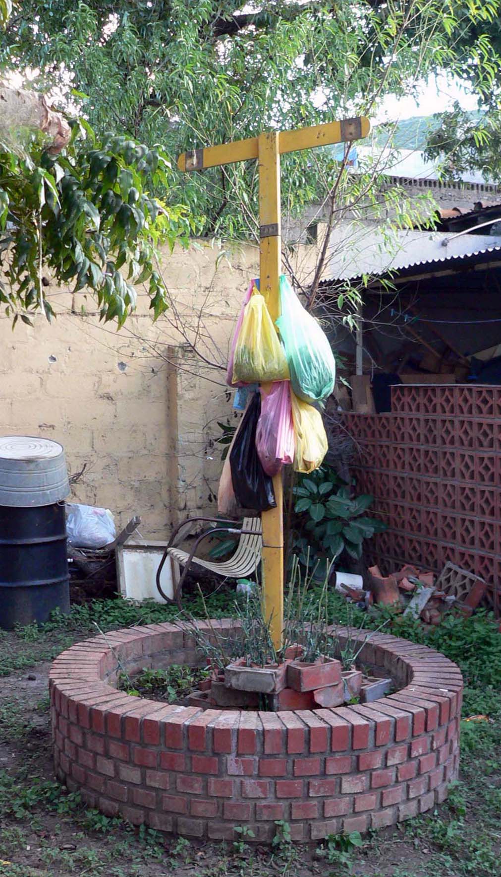 Regio, In-situ sculpture, Collected debris, plastic shopping bags, found wood in planter, Co-Habitat, Nuevo Leon, MX. 2007