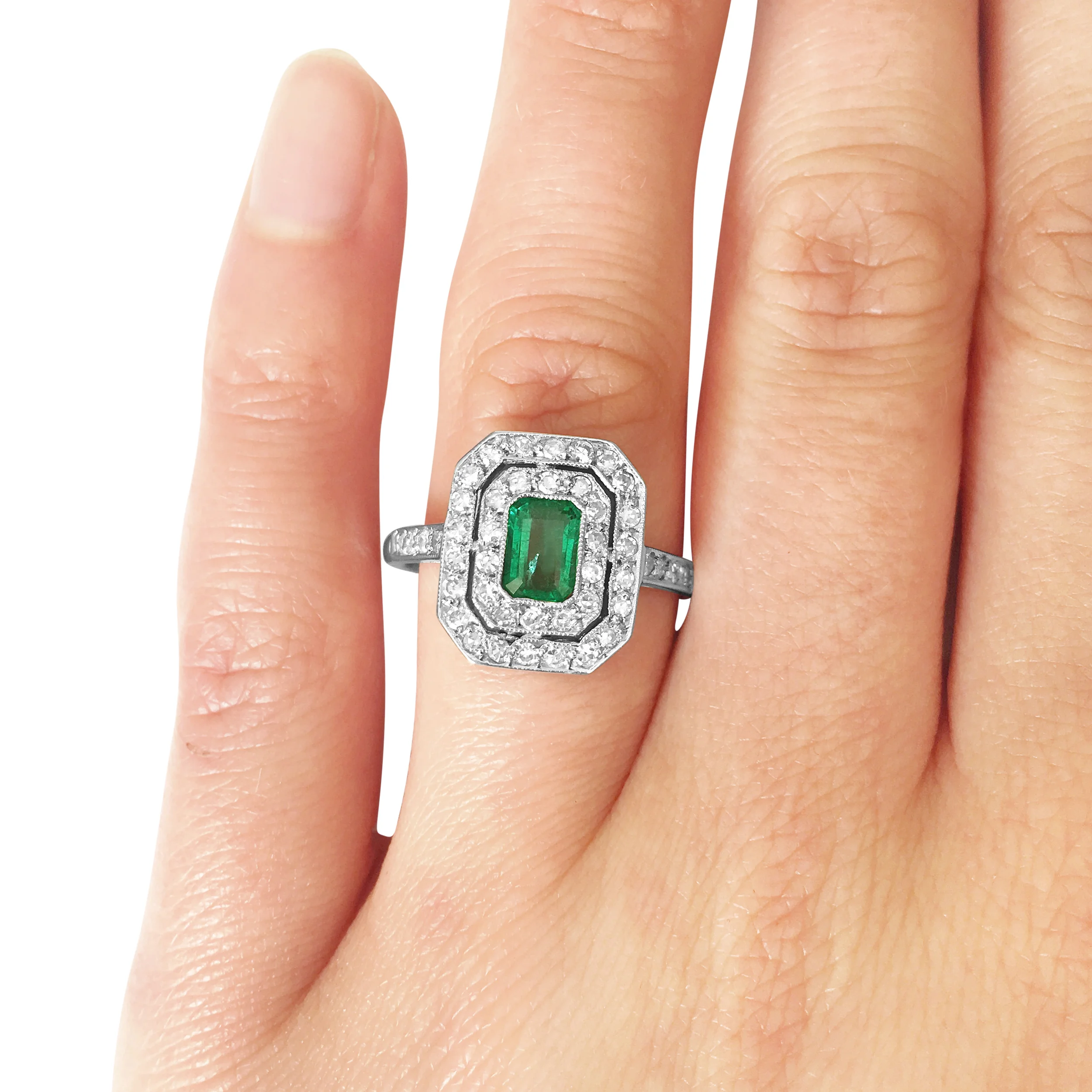 emerald and diamond two-row ring hand shot
