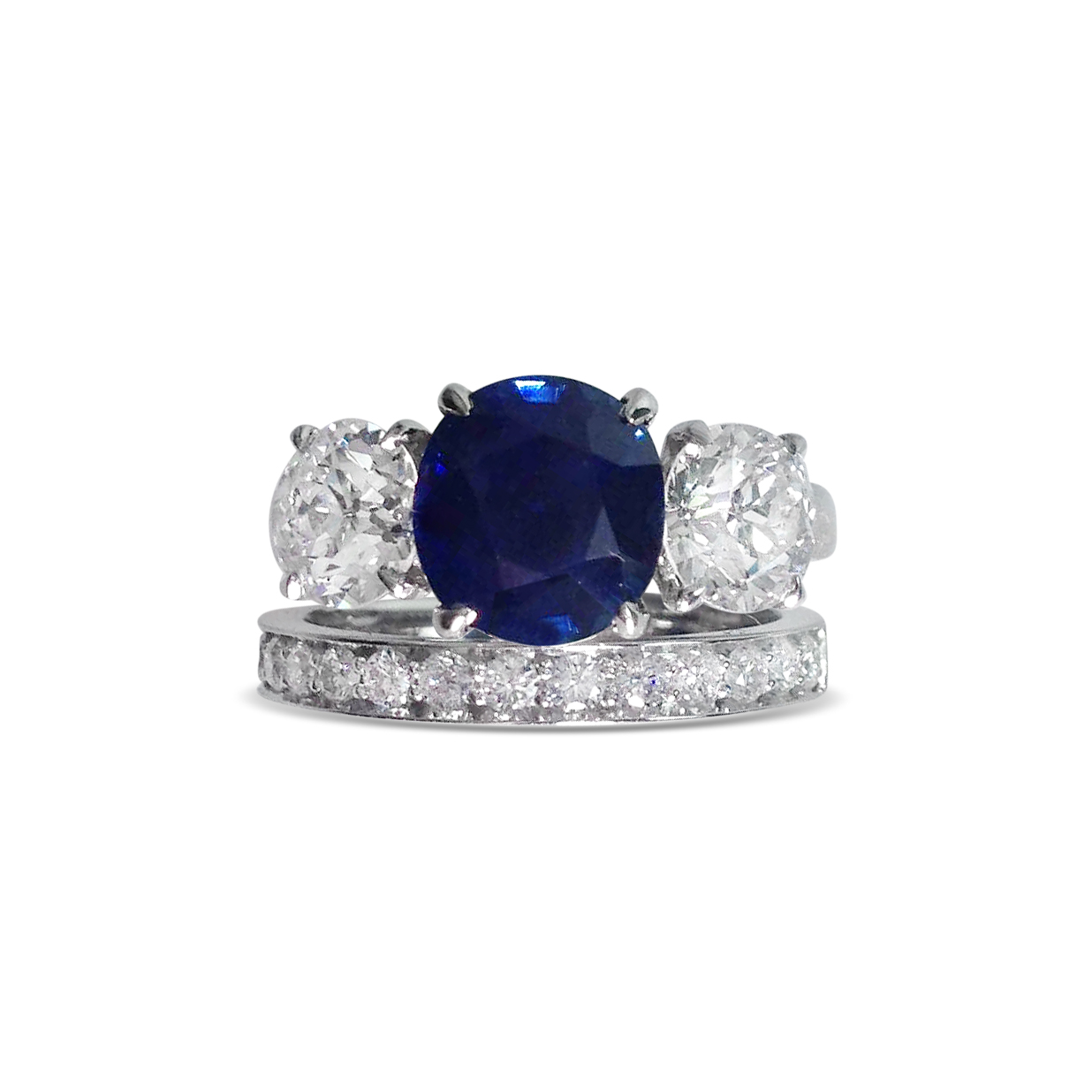 sapphire-and-diamond-three-stone-ring-mounted-in-platinum-with-hald-set-platinum-wedding-band.jpg