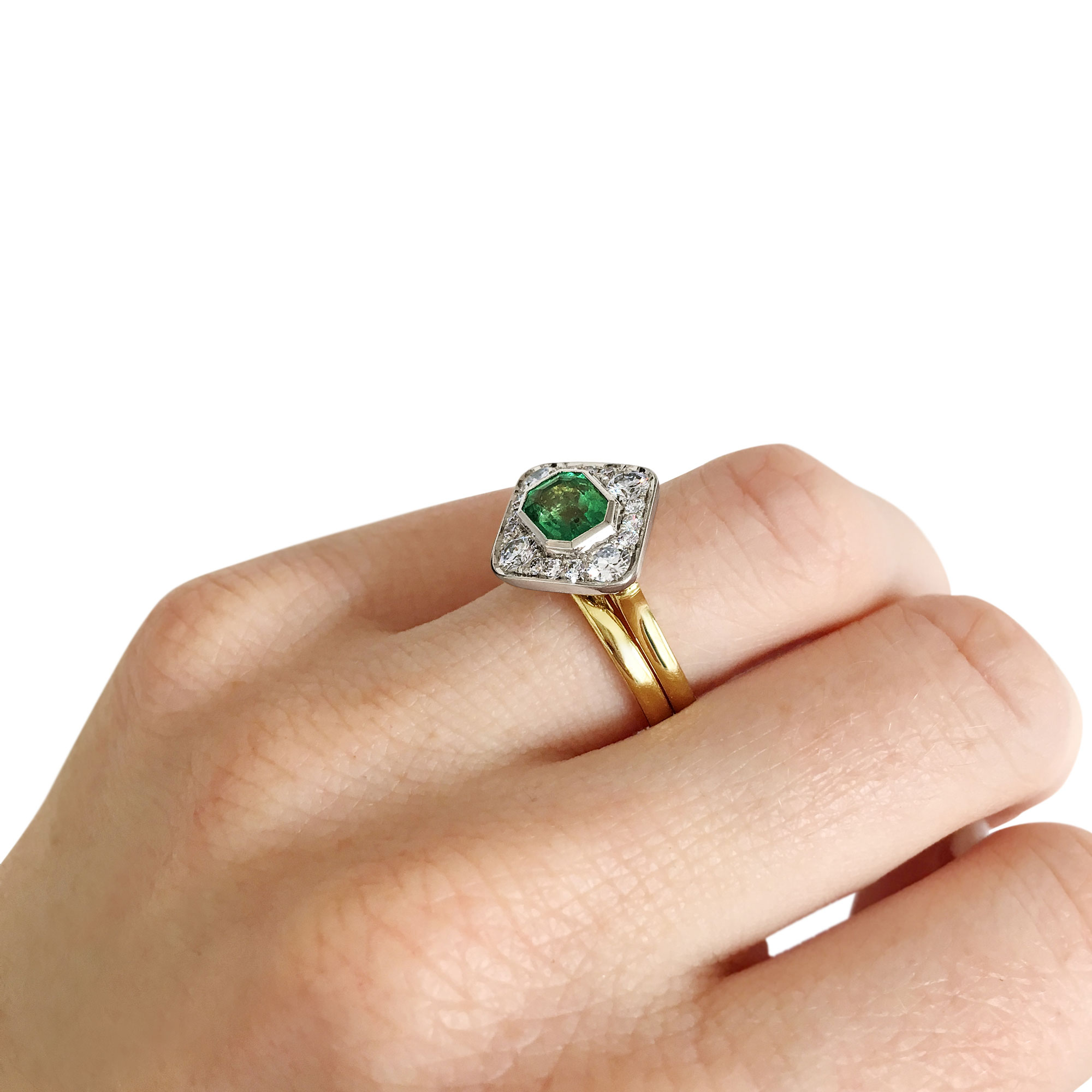 Emerald and diamond panel ring mounted in 18ct white and yellow gold on hand