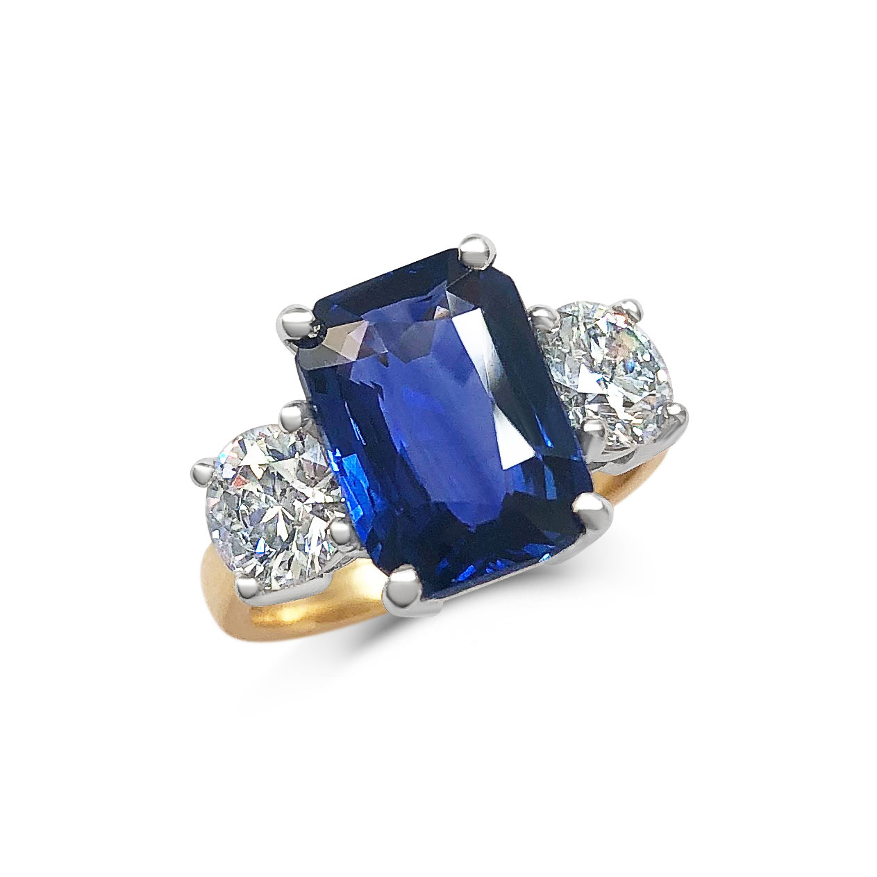 Emerald-cut Sapphire and diamond three stone ring set in 18ct yellow gold