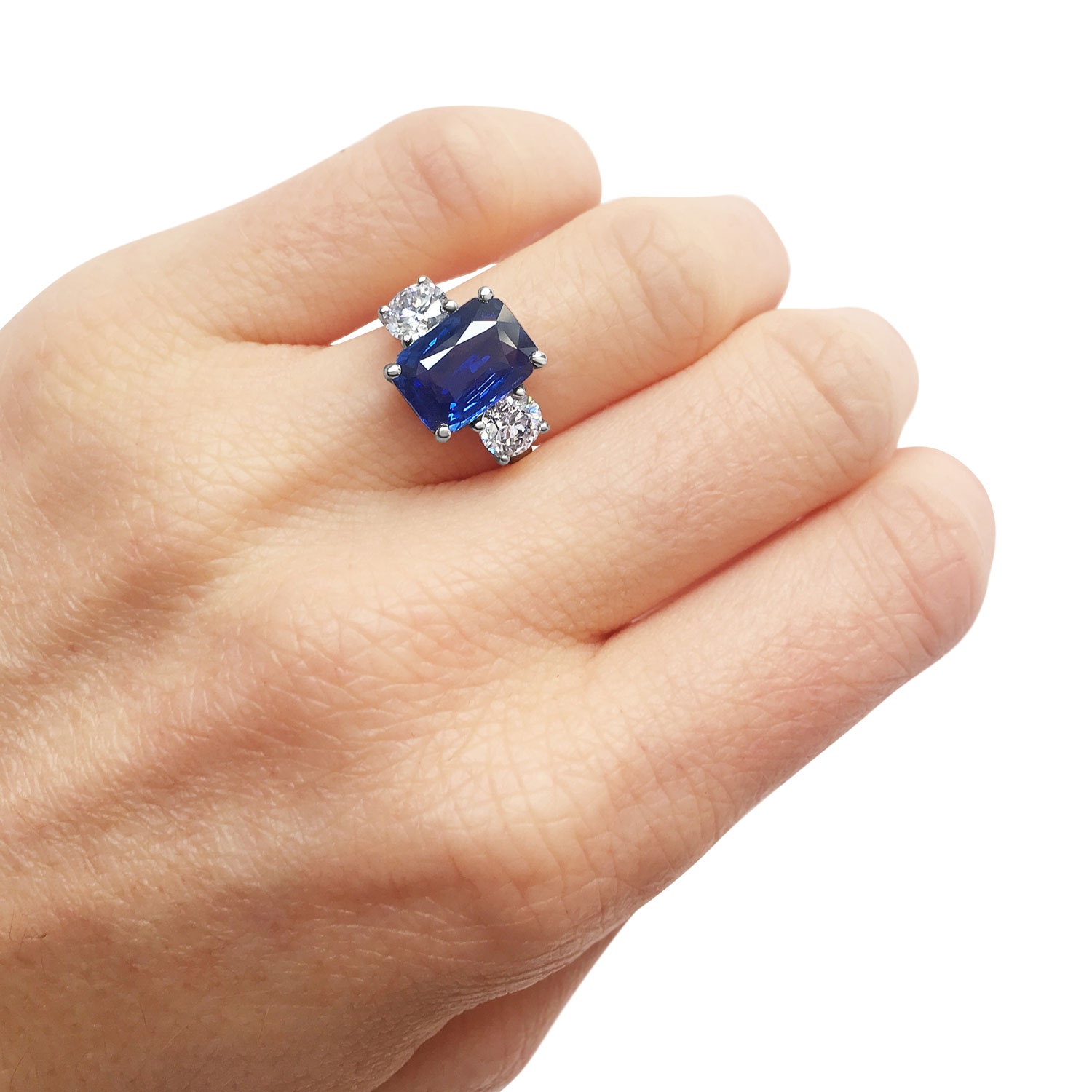 Emerald-cut Sapphire and diamond three stone ring set in 18ct yellow gold.