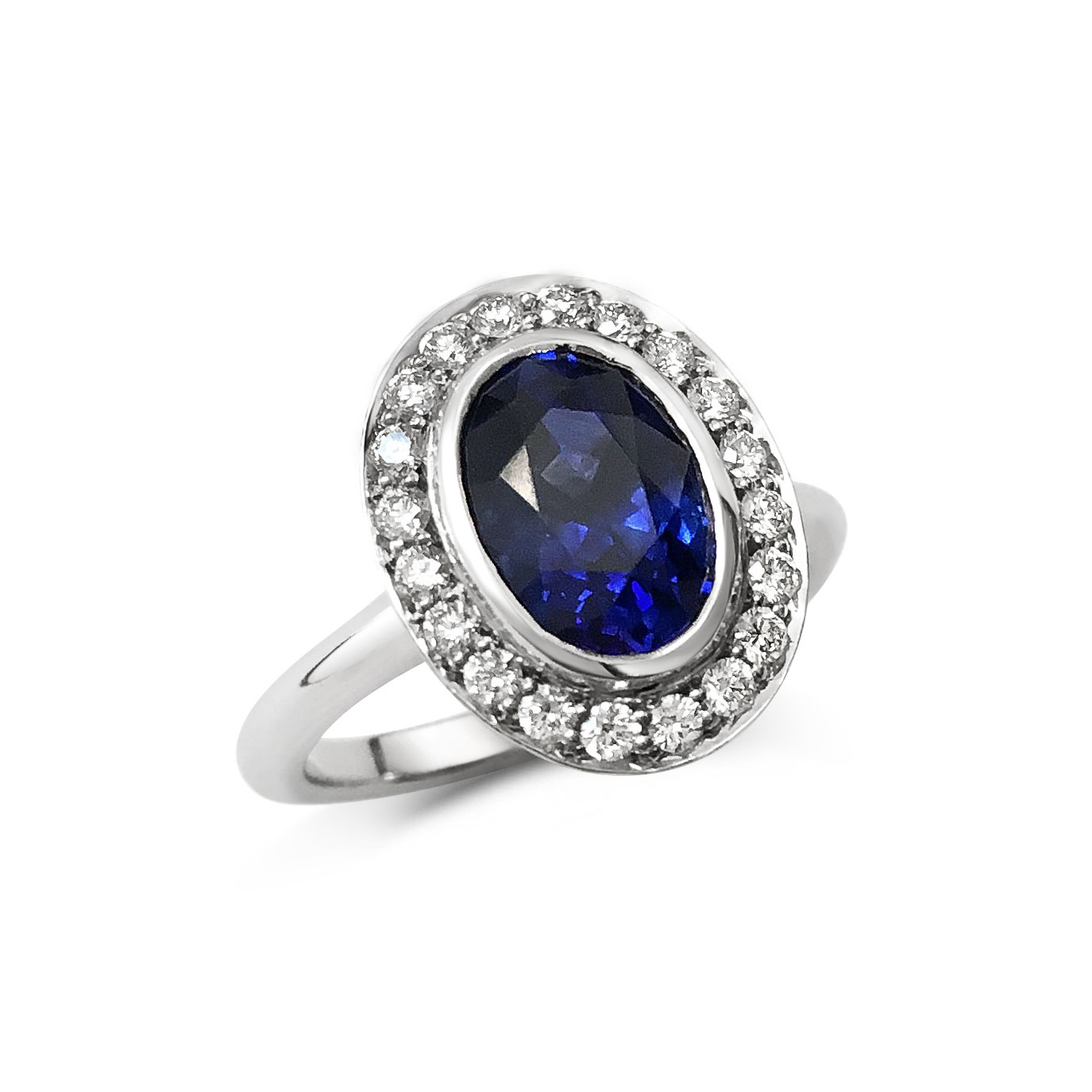 Oval sapphire with diamond halo engagement ring, mounted in platinum. 