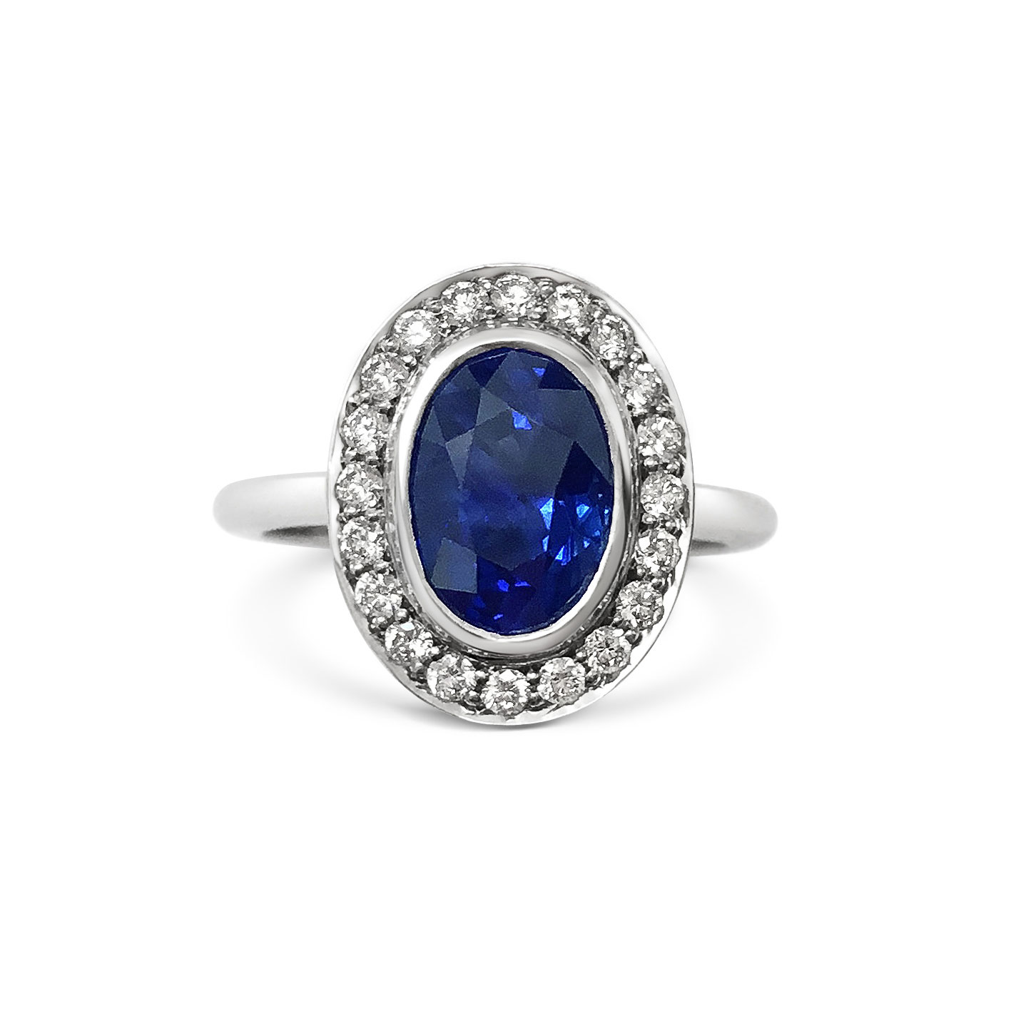 Oval sapphire with diamond halo engagement ring, mounted in platinum. 