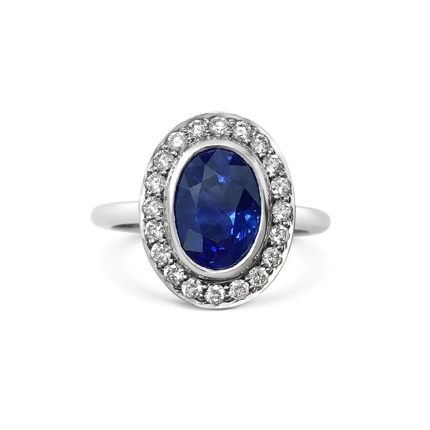 Oval sapphire with diamond halo engagement ring, mounted in platinum.