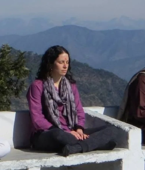 Meditating with the Himalayas in the background on my first trip to India. 