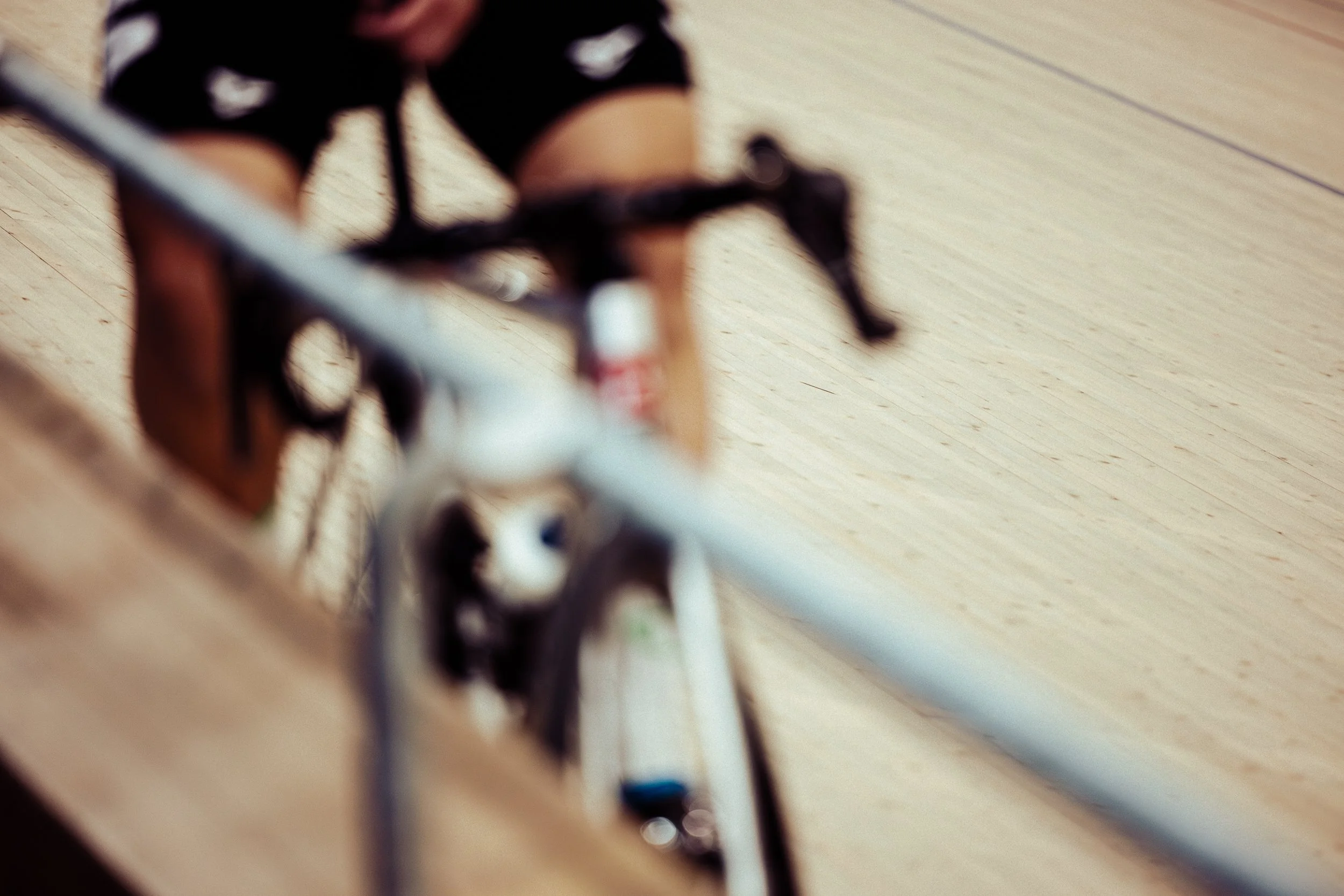 Close-up of a bicycle leaning against a wooden surface with a blurred background.