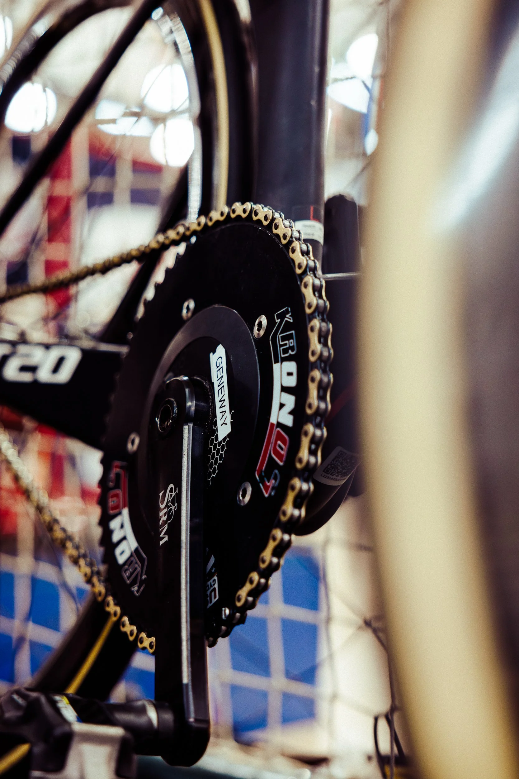 Close-up of a bicycle's rear gear and chain, focusing on the crankset and part of the frame.