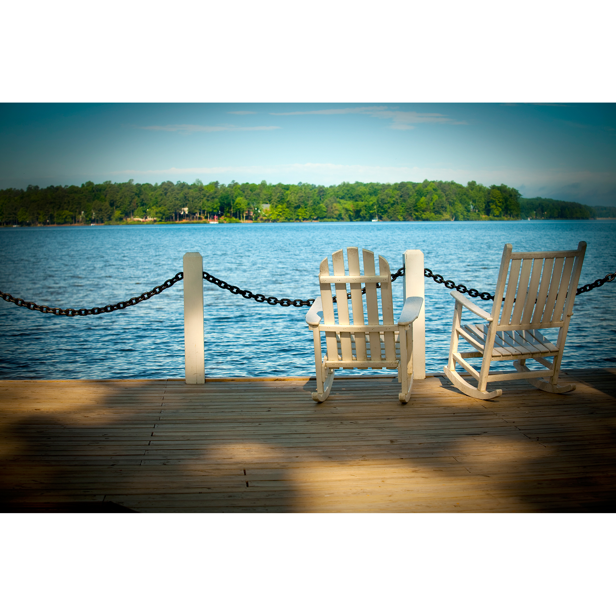 Editorial photograph of rocking chairs overlooking water