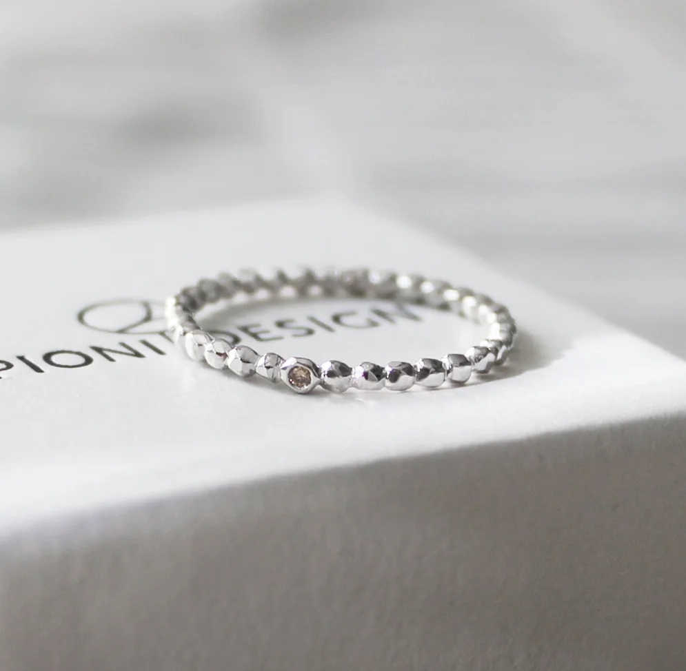 Engagement ring, white gold with a natural color diamond.