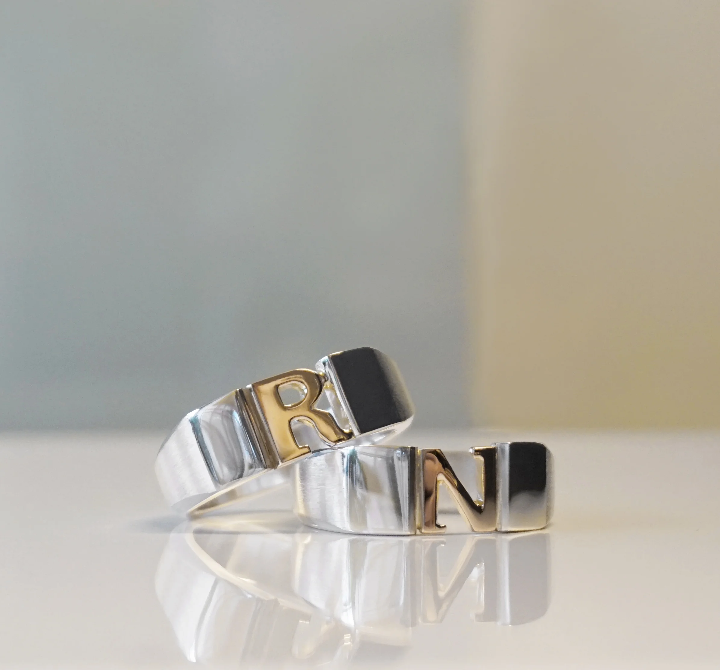 Silver rings with golden letters. Made for a Finnish singer and song writer.