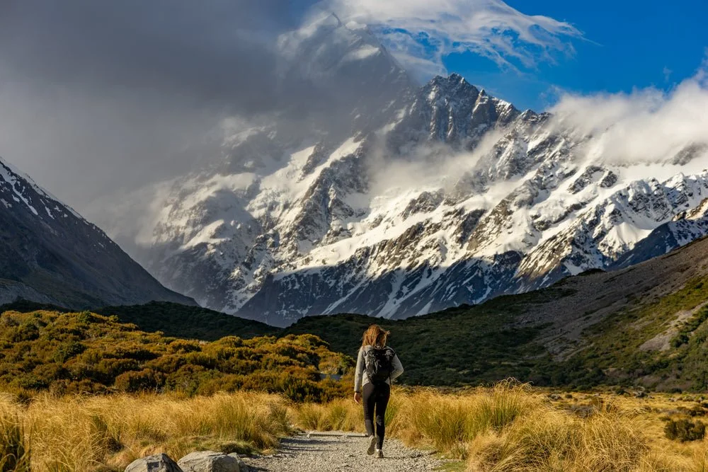 hiker-approaches-snow-capped-mountains.jpg