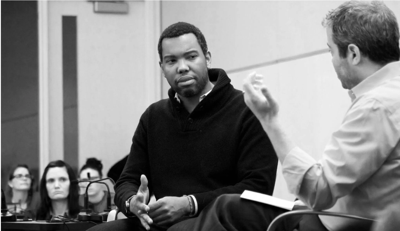 Ta-Nehisi Coates and Matthew Lieberman sitting down in conversation in a large room of teachers in Minneapolis.