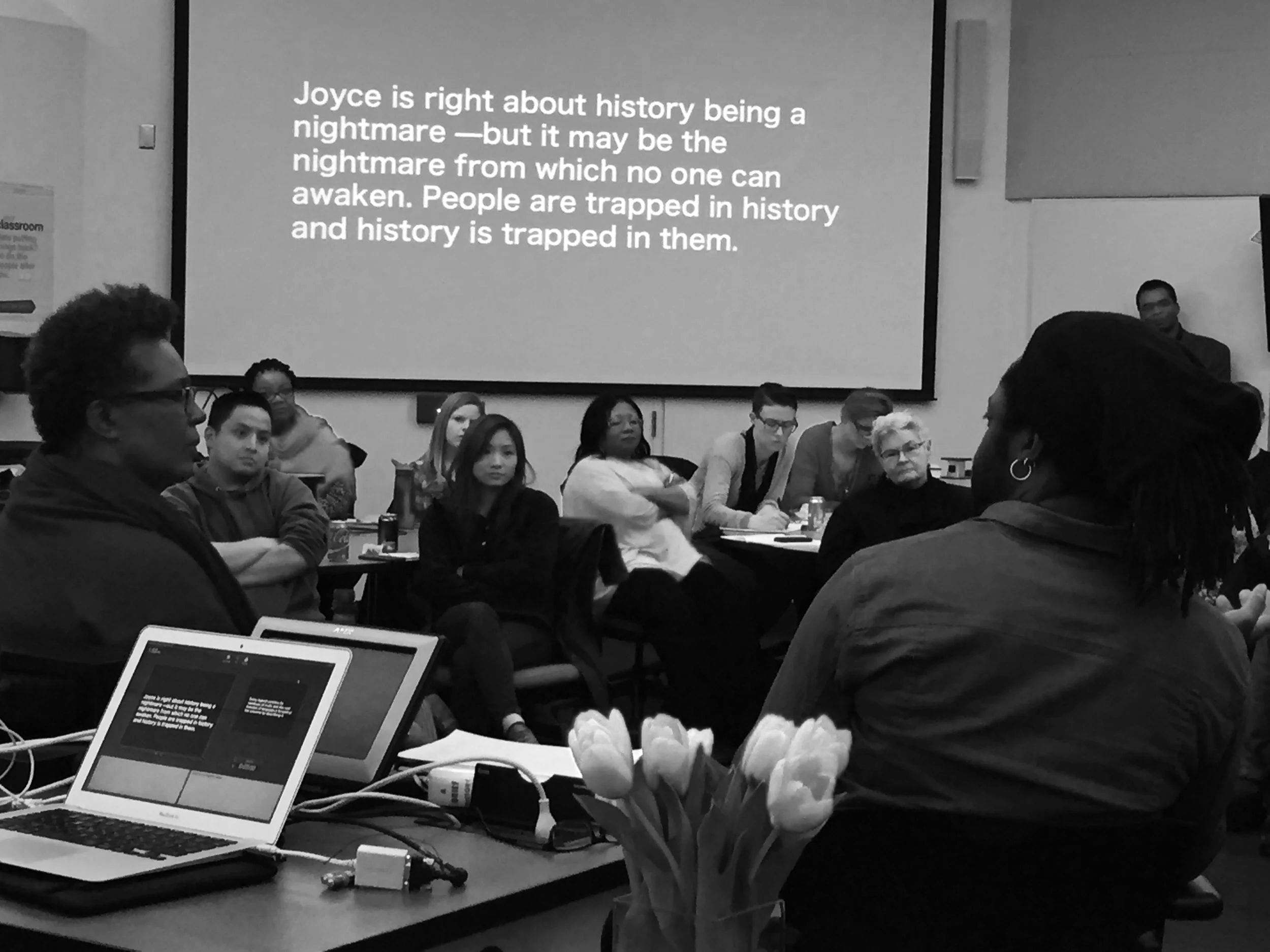 Rankine and James sitting in front of audience and Baldwin quote on display